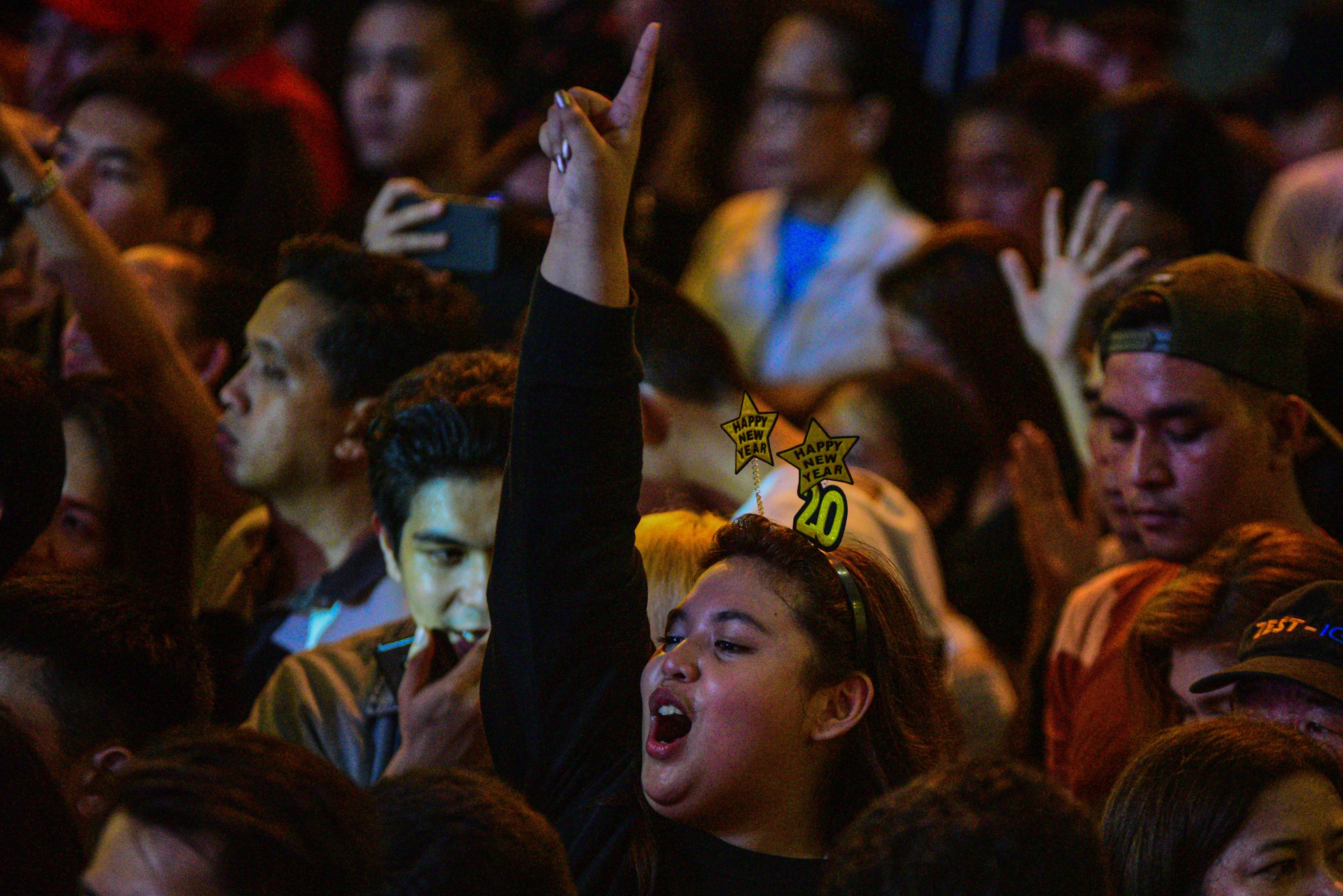  People cheer during New Year celebrations in Manila on January 1, 2020. 
