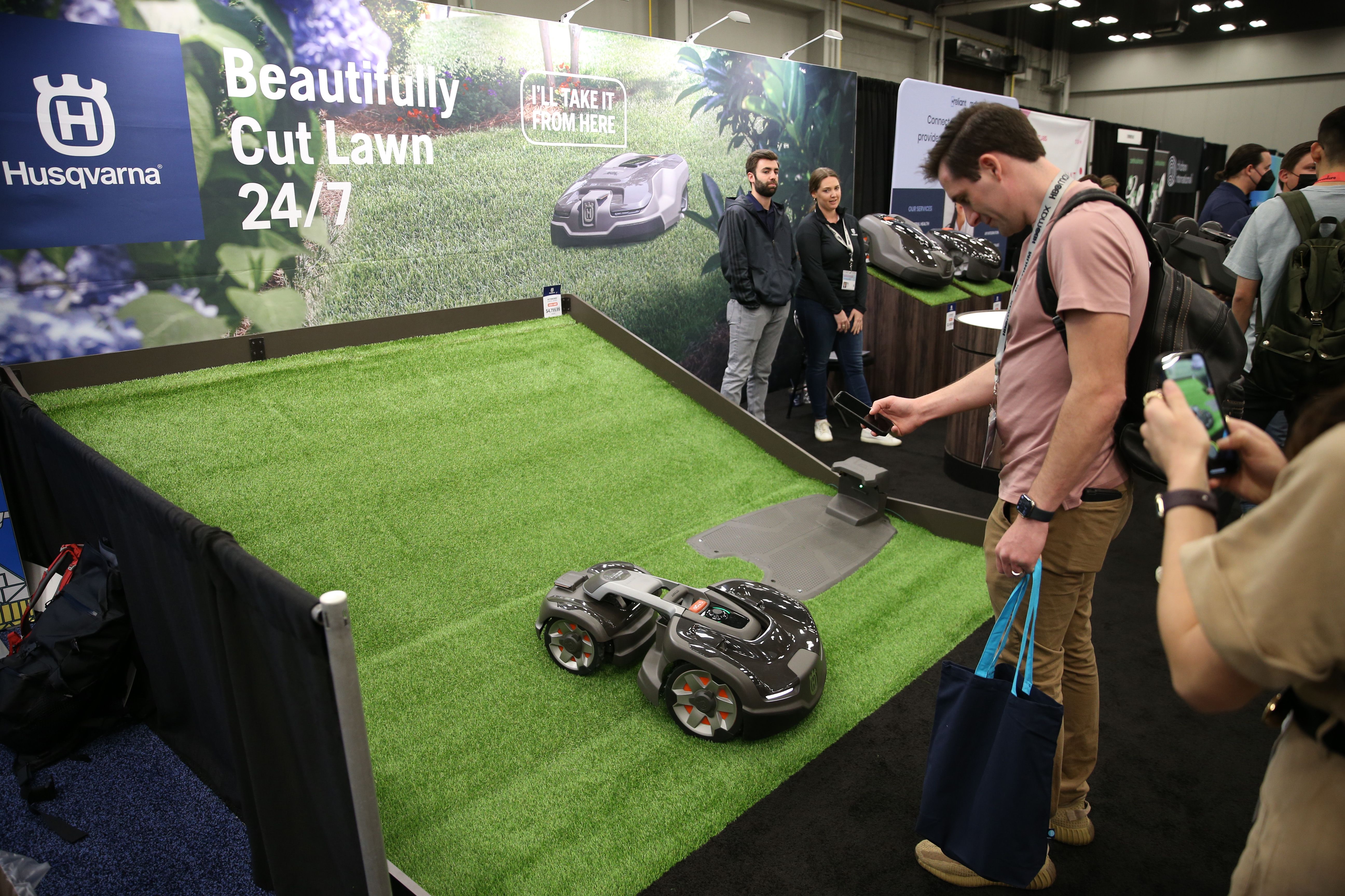 A Husqvarna lawn mower in a demonstration area at a trade show.