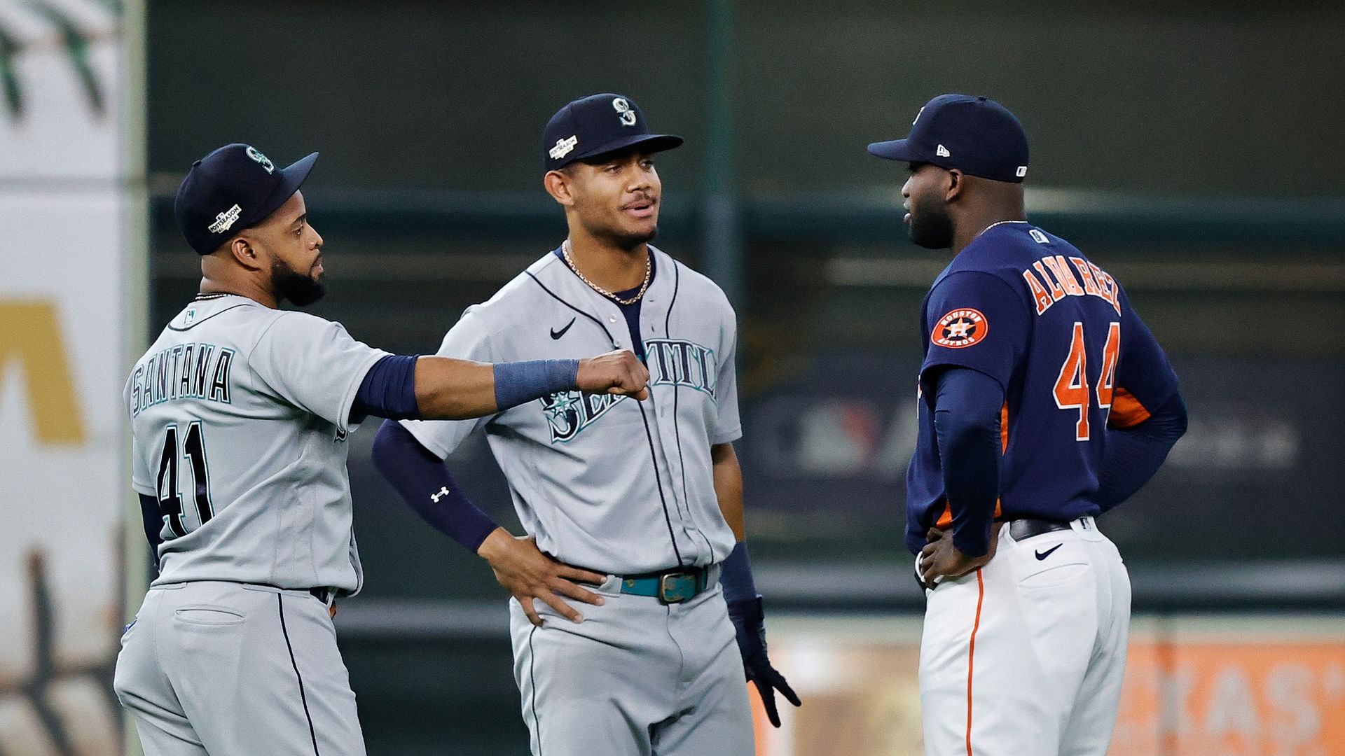 Carlos Santana #41 of the Seattle Mariners, Julio Rodriguez #44 and Yordan Alvarez #44 of the Houston Astros talk before the game in the Division Series at Minute Maid Park.