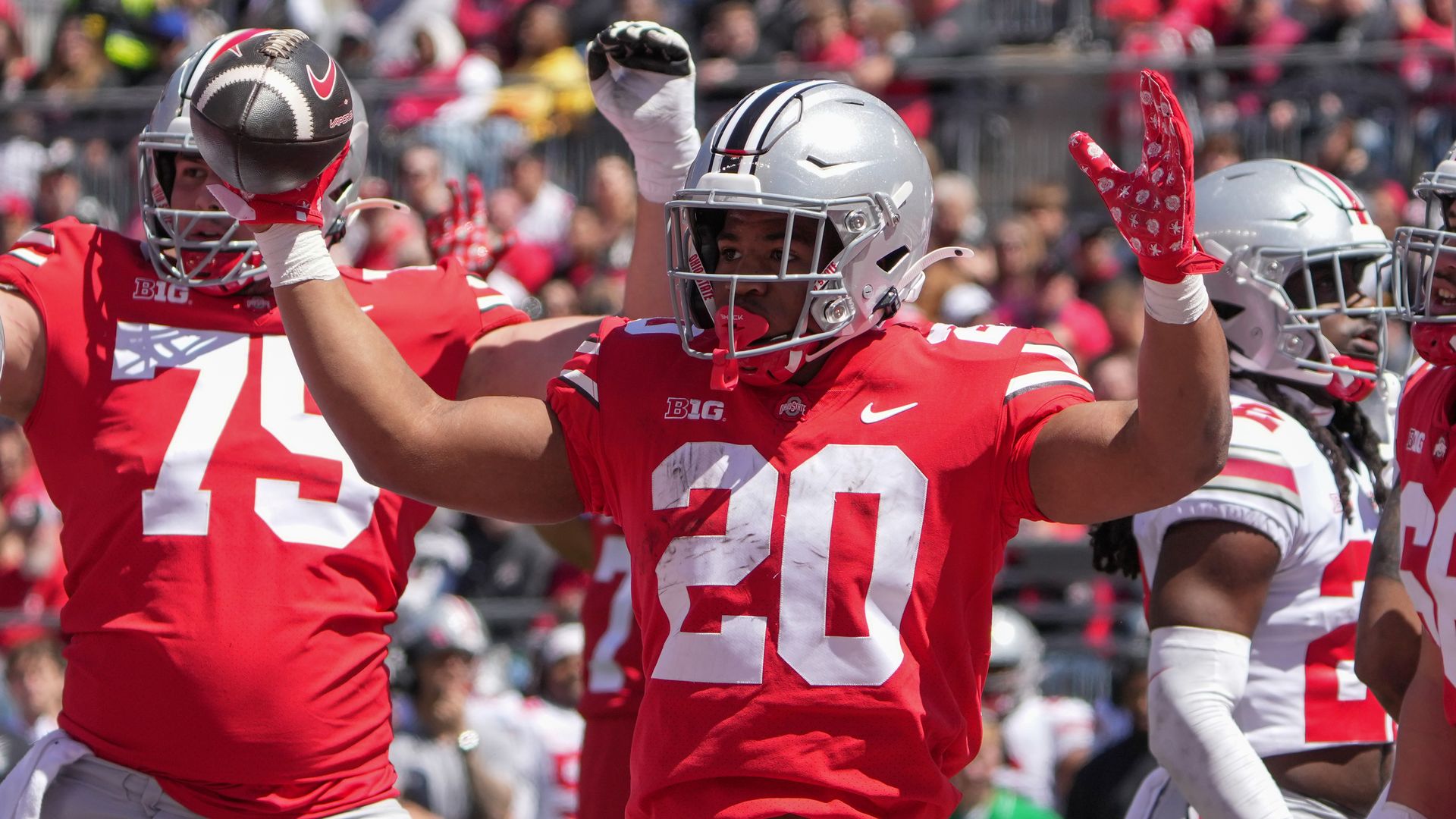 An Ohio State player holds up his hands to signal a touchdown. 