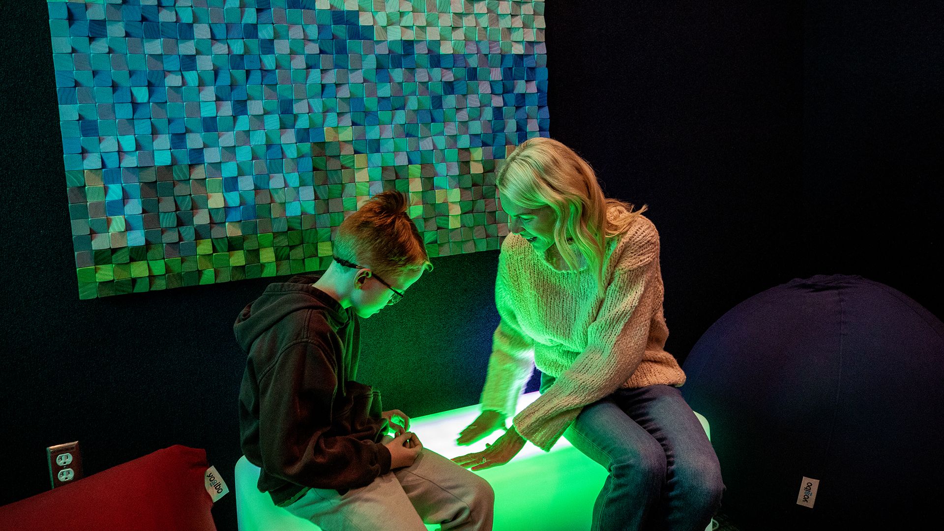 A woman and her son check out the new sensory room at the airport.
