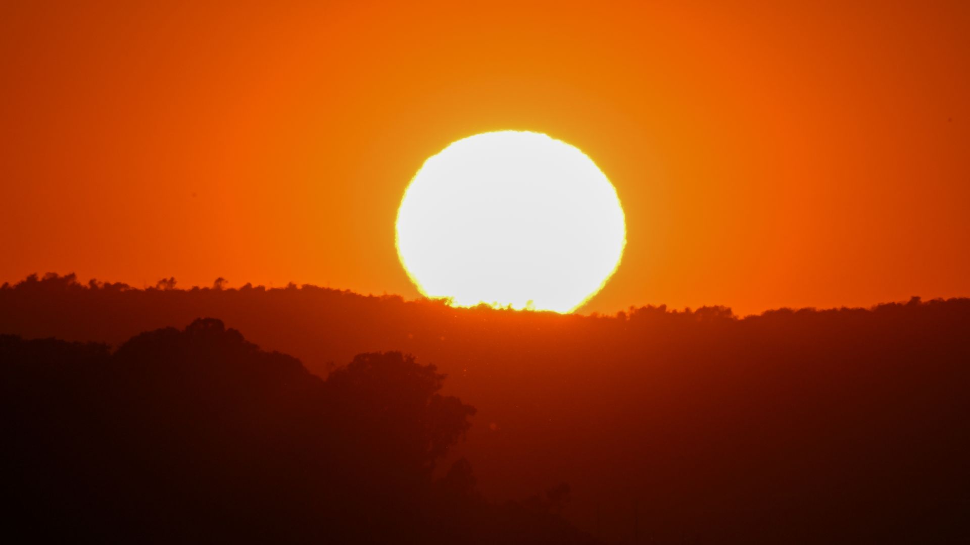 Photo of sun setting over mountains
