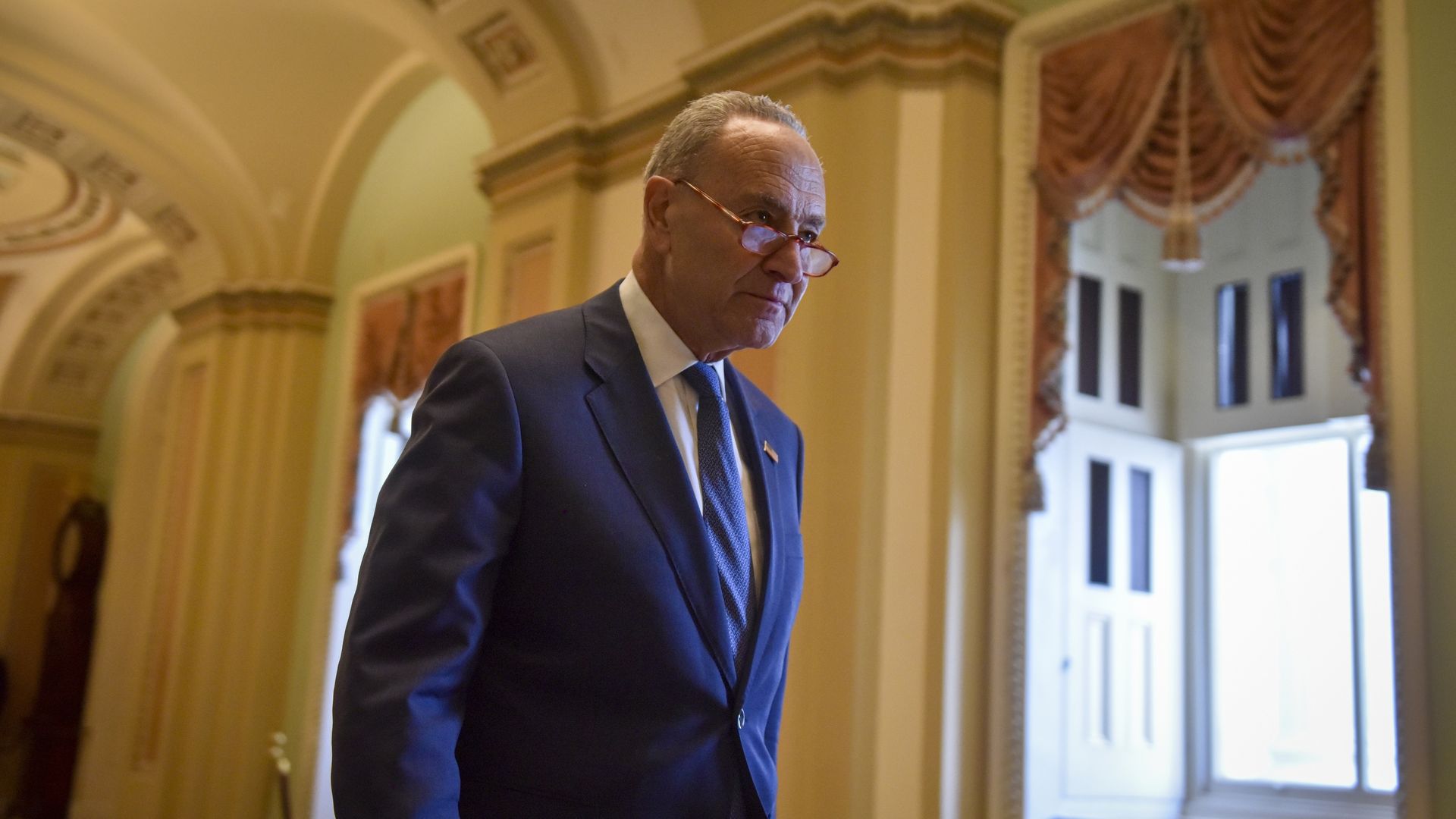 Photo of Chuck Schumer walking in the halls of the Capitol