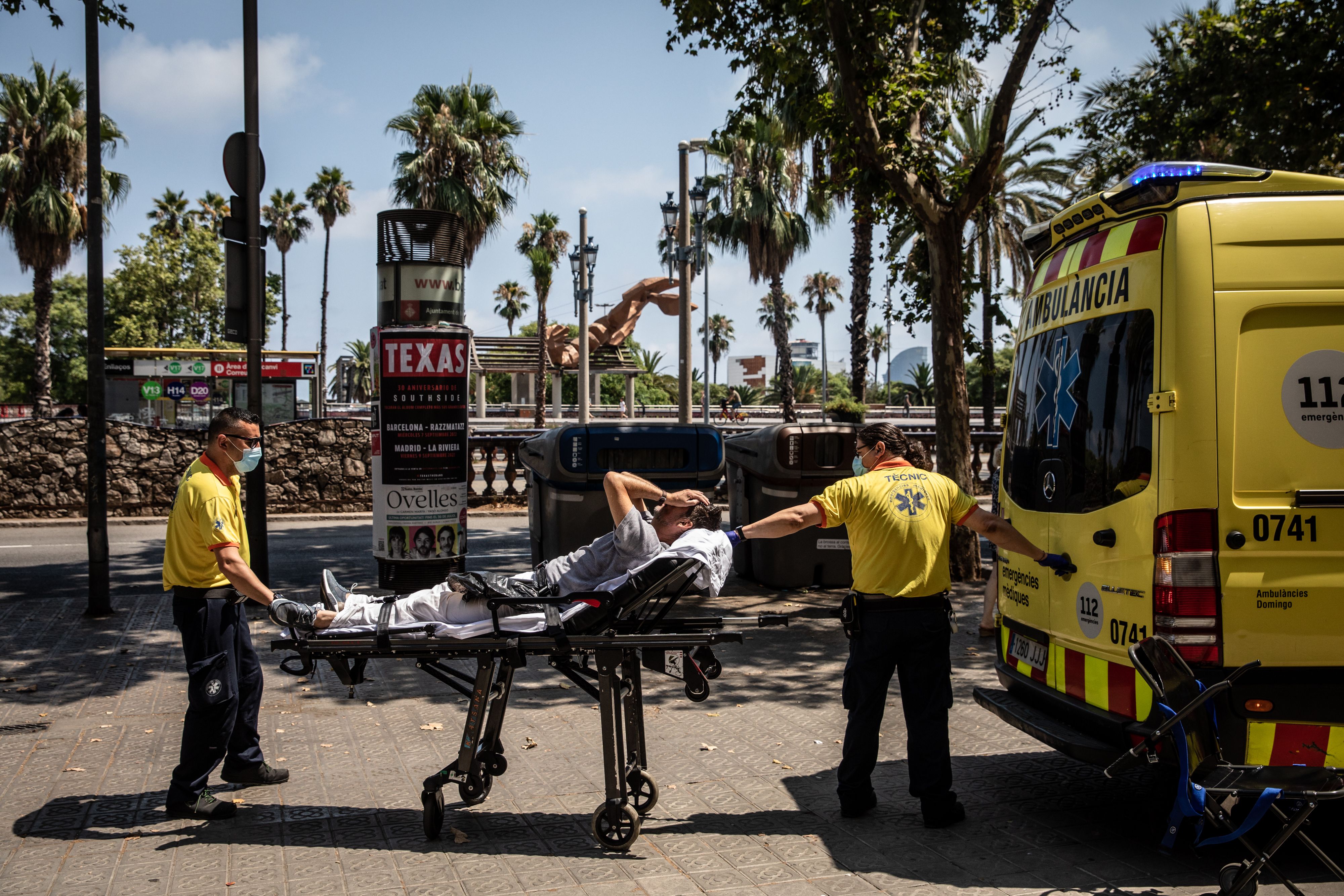 Paramedics help a patient into an ambulance during a heat wave in Barcelona, Spain, on Monday, July 18, 2022. The heat wave killed 360 people dead in Spain between July 10 and 15, Instituto de Salud Carlos III said on Saturday.