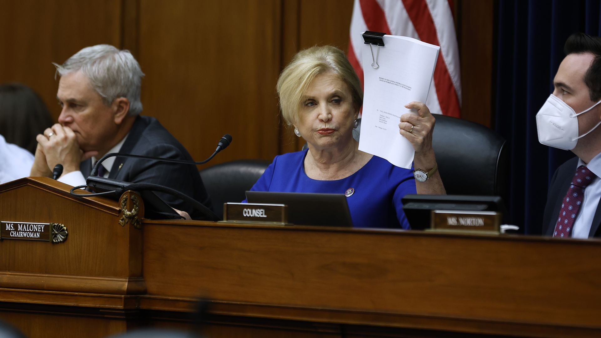 Rep. Carolyn Maloney holds up a report at a House Oversight Committee hearing