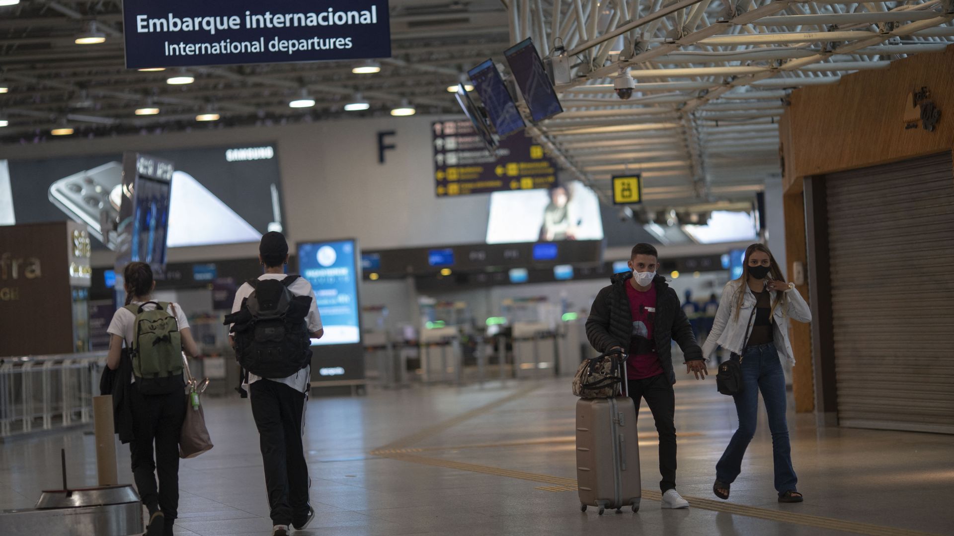 People walk at the boarding area at the Galeao International airport in Rio de Janeiro, Brazil on April 13