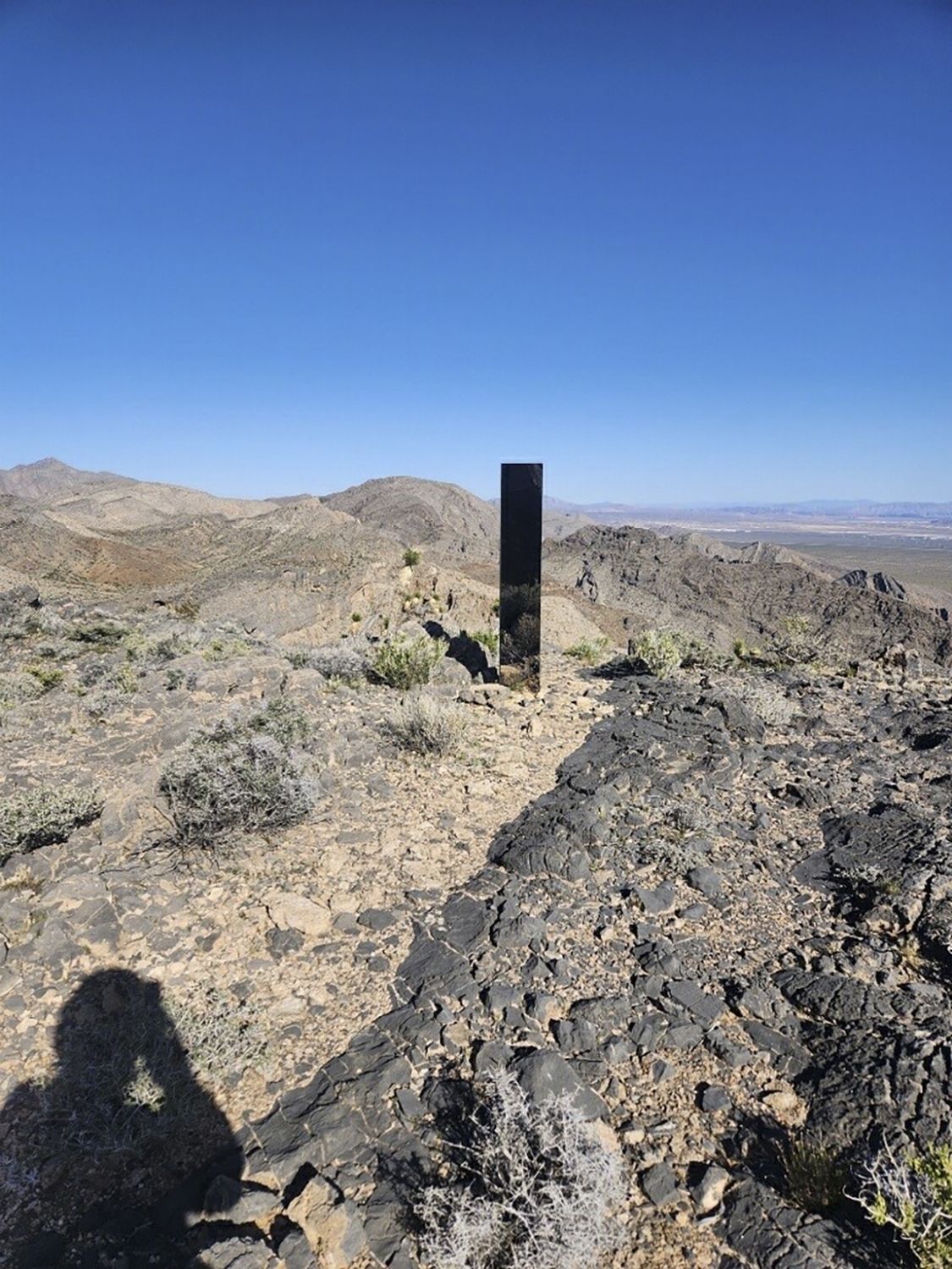 This photo provided by Las Vegas Metropolitan Police Department shows a monolith near Gass Peak, Nevada on Sunday, June 16, 2024. Jutting out of the rocks on a remote mountain peak near Las Vegas, the glimmering rectangular prism's reflective surface imitates the vast desert landscape surrounding th