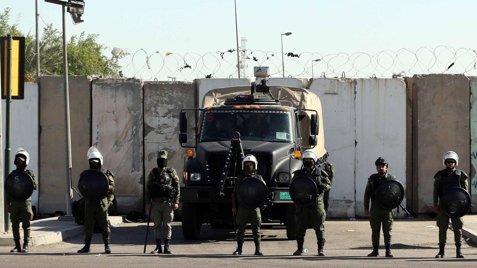 Iraqi riot police stand guard near the Green Zone in Baghdad.