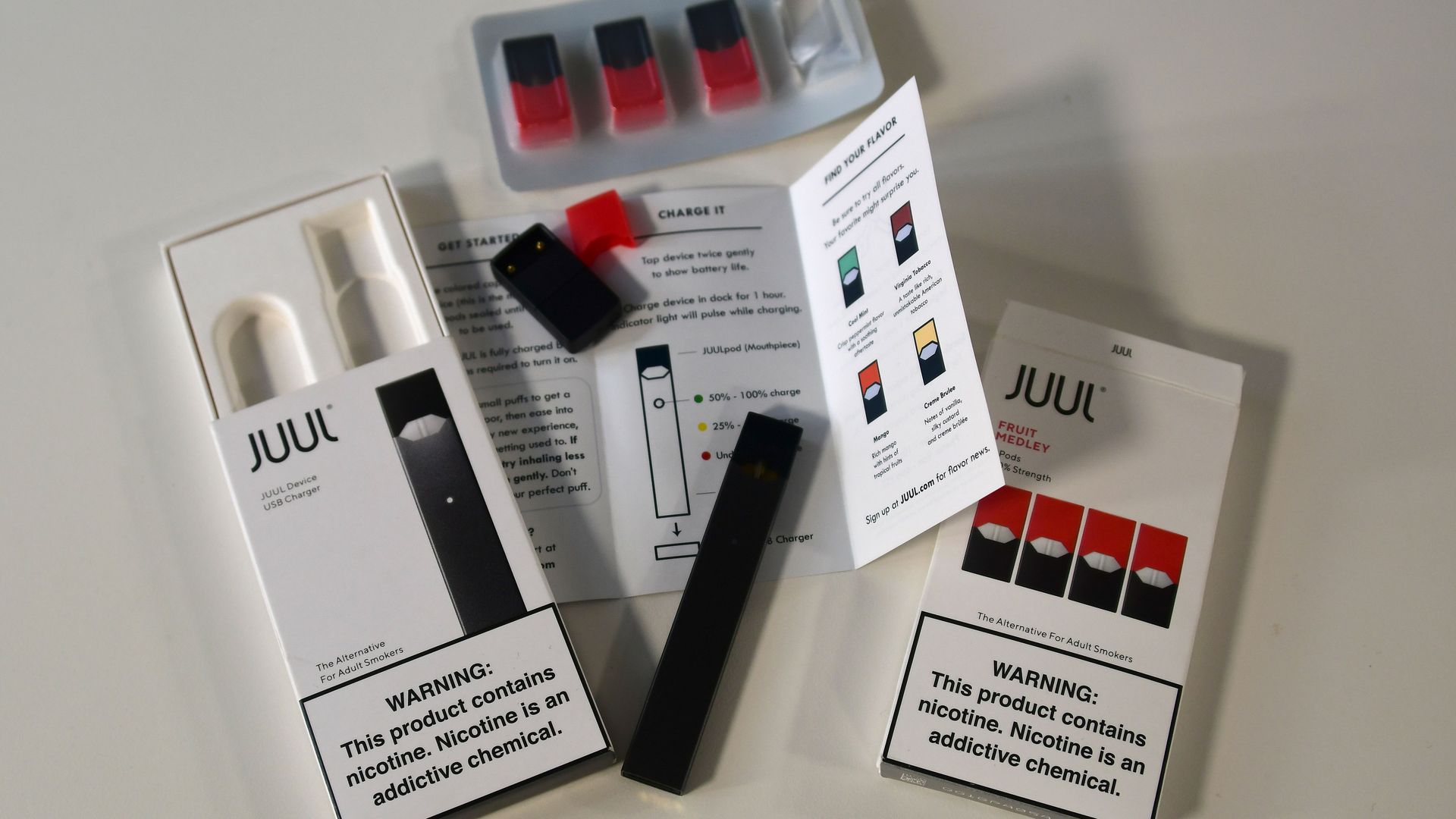 In this image, a Juul kit is unpacked and displayed.
