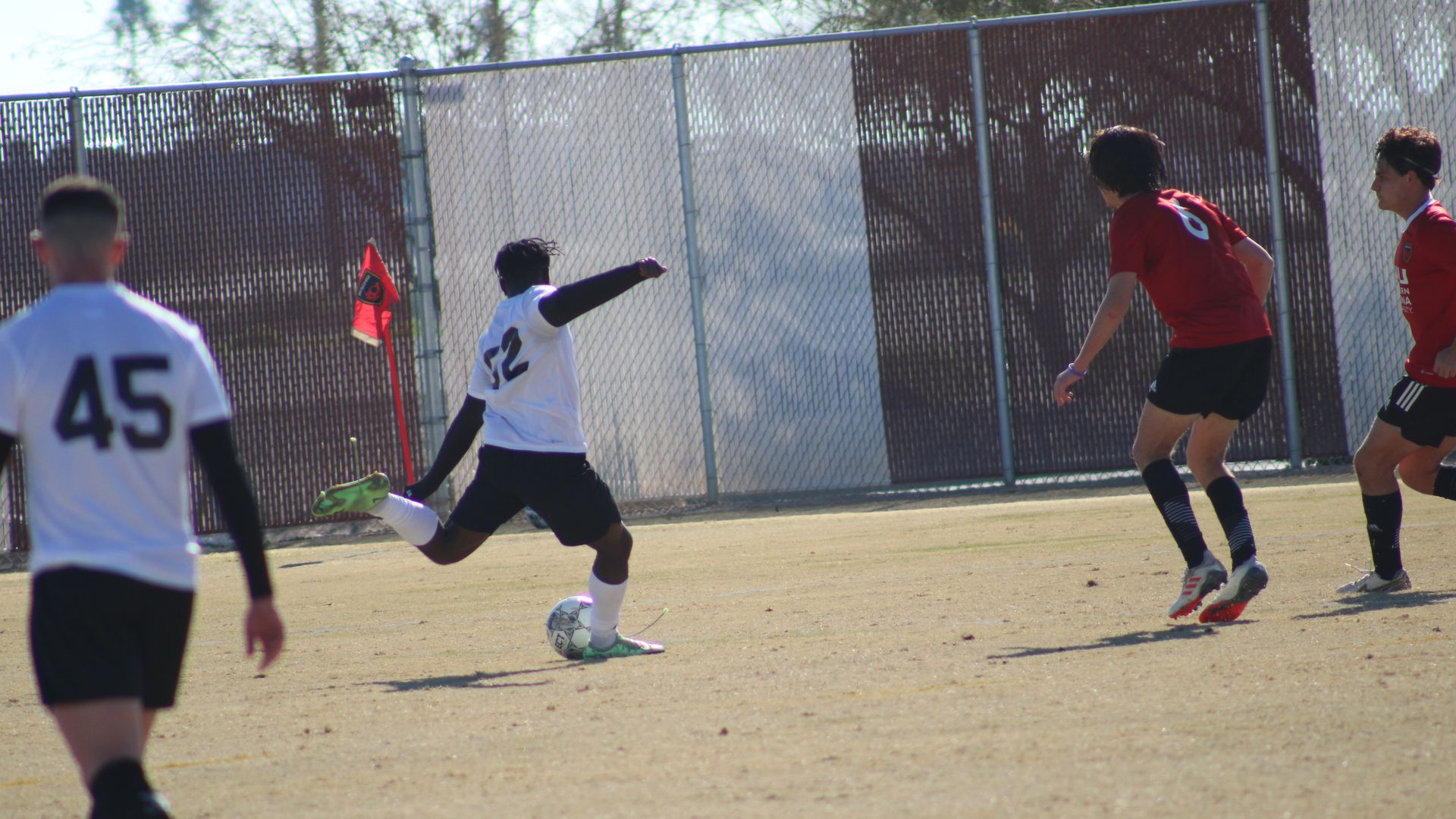 A soccer player prepares to kick the ball.