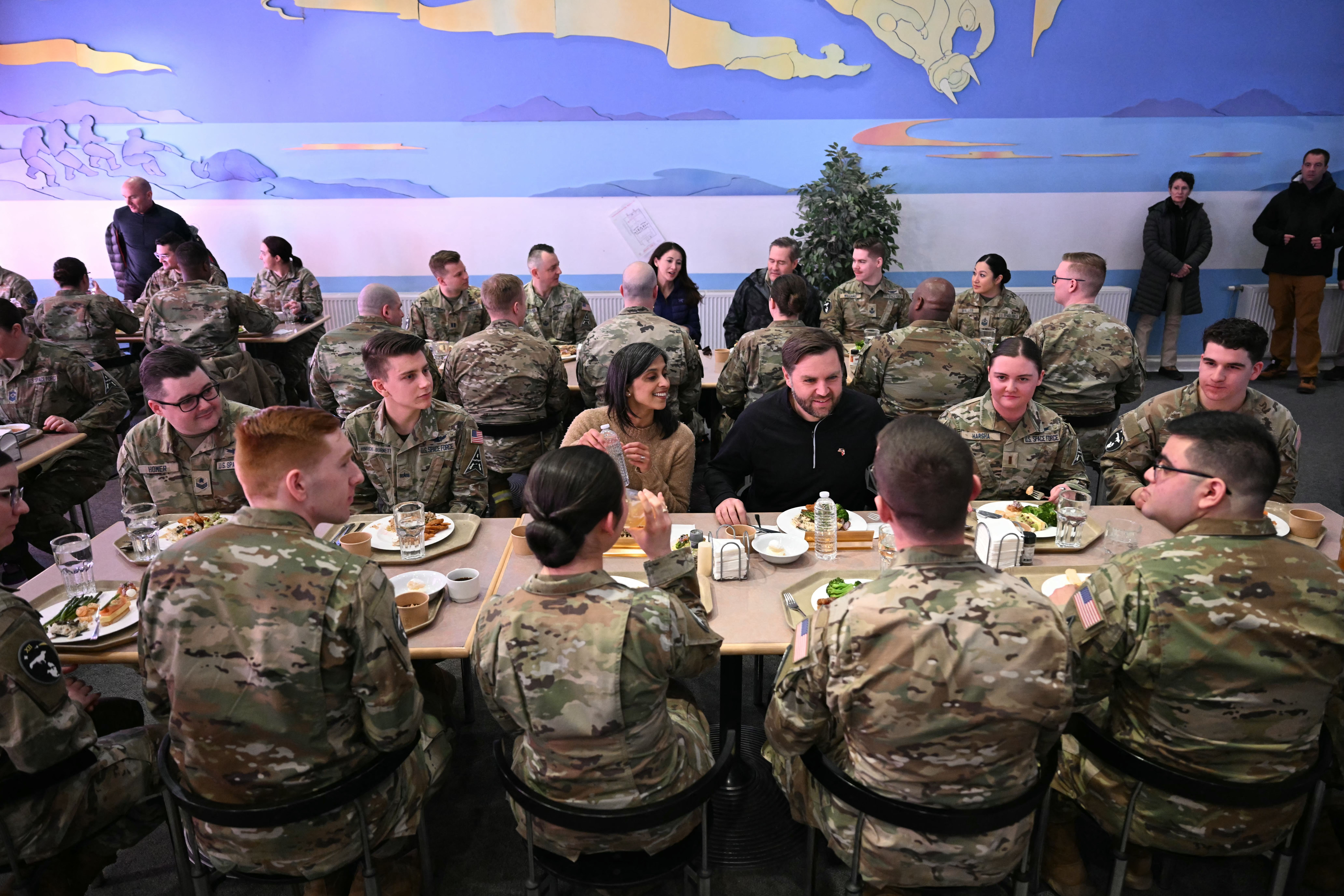 ice President JD (C R) and Second Lady Usha Vance (C L) eat a meal with soldiers at the US military's Pituffik Space Base in Greenland on March 28, 2025. The visit is viewed by Copenhagen and Nuuk as a provocation amid President Donald Trump's bid to annex the strategically-placed, resource-rich Dan