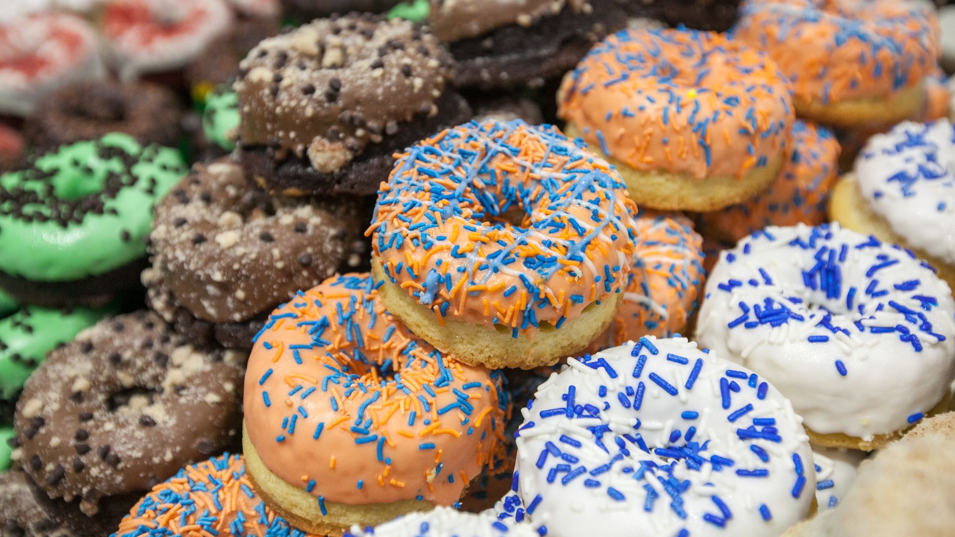 An assortment of donuts frosted in multiple colors