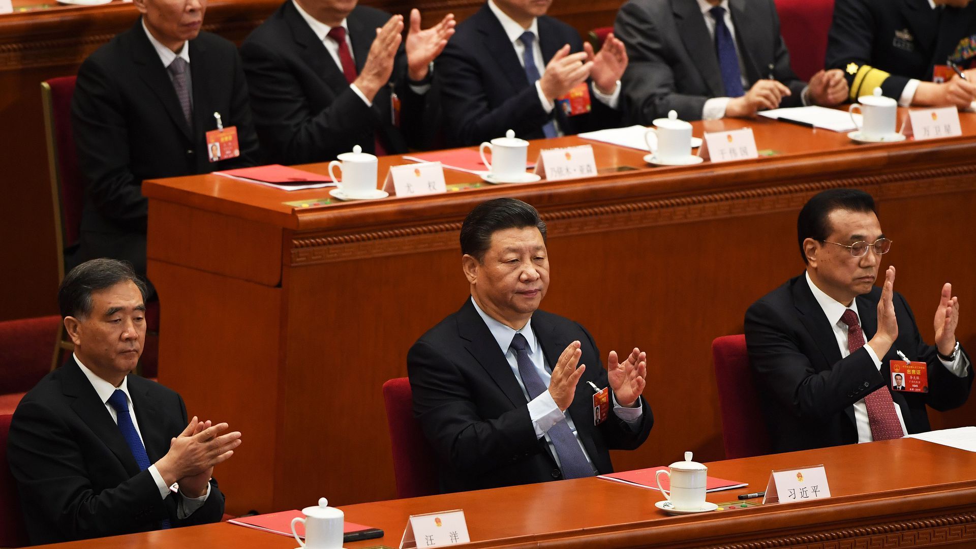 President Xi Jinping and other Chinese officials applaud at the National People's Congress.