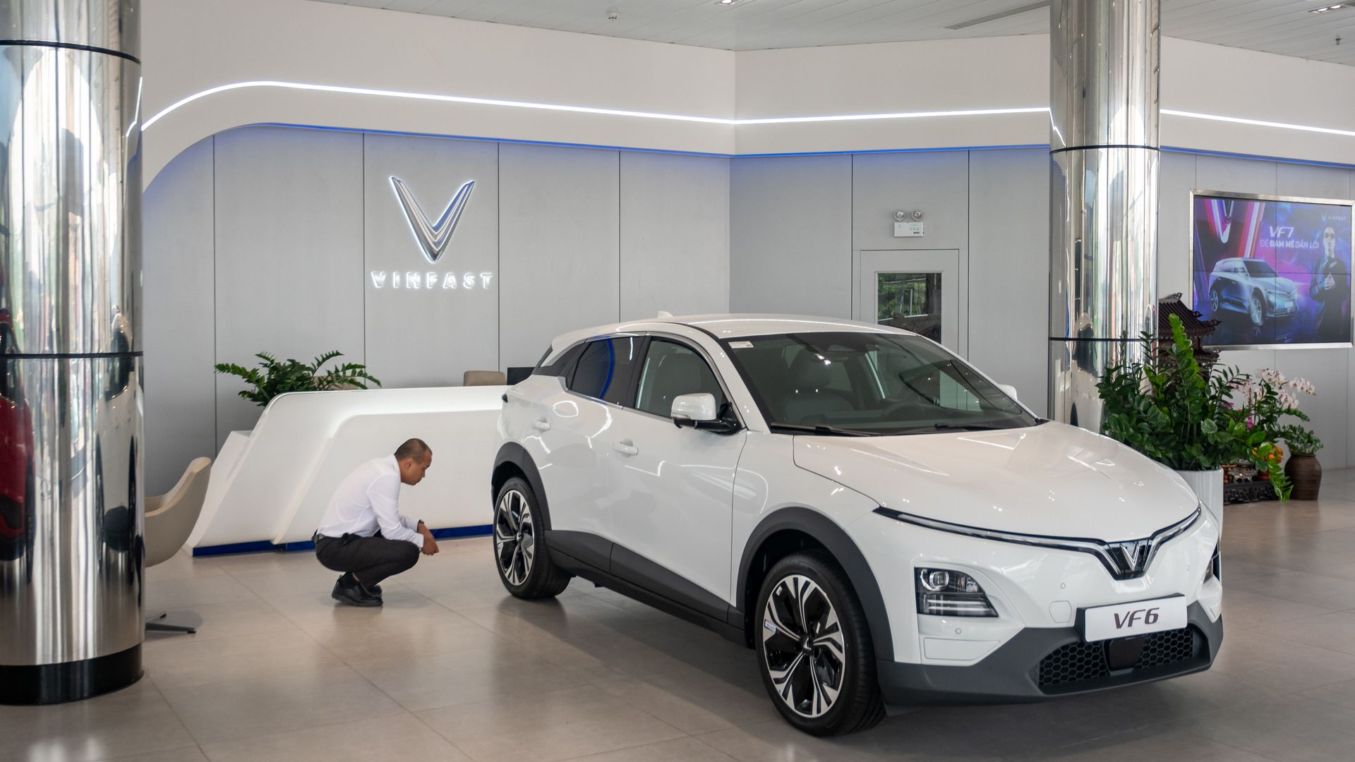 A customer inspects a VinFast Auto Ltd. electric vehicle VF 6 model at a company's showroom in Hanoi, Vietnam, on Friday, May 10, 2024. The EV maker controlled by Pham Nhat Vuong is trying to break into the global market at a time when Chinese competitors are increasing exports while Tesla Inc. slas