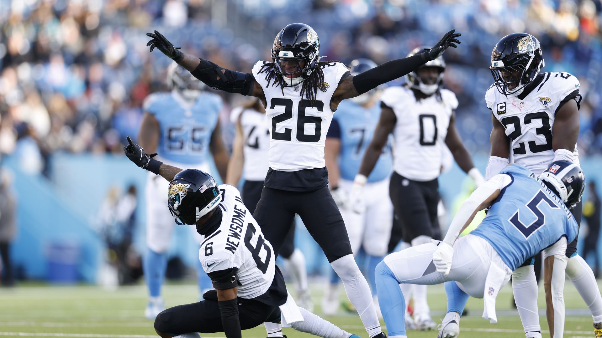 Jaguars players celebrate a pass breakup during their win over the Titans on Sunday.