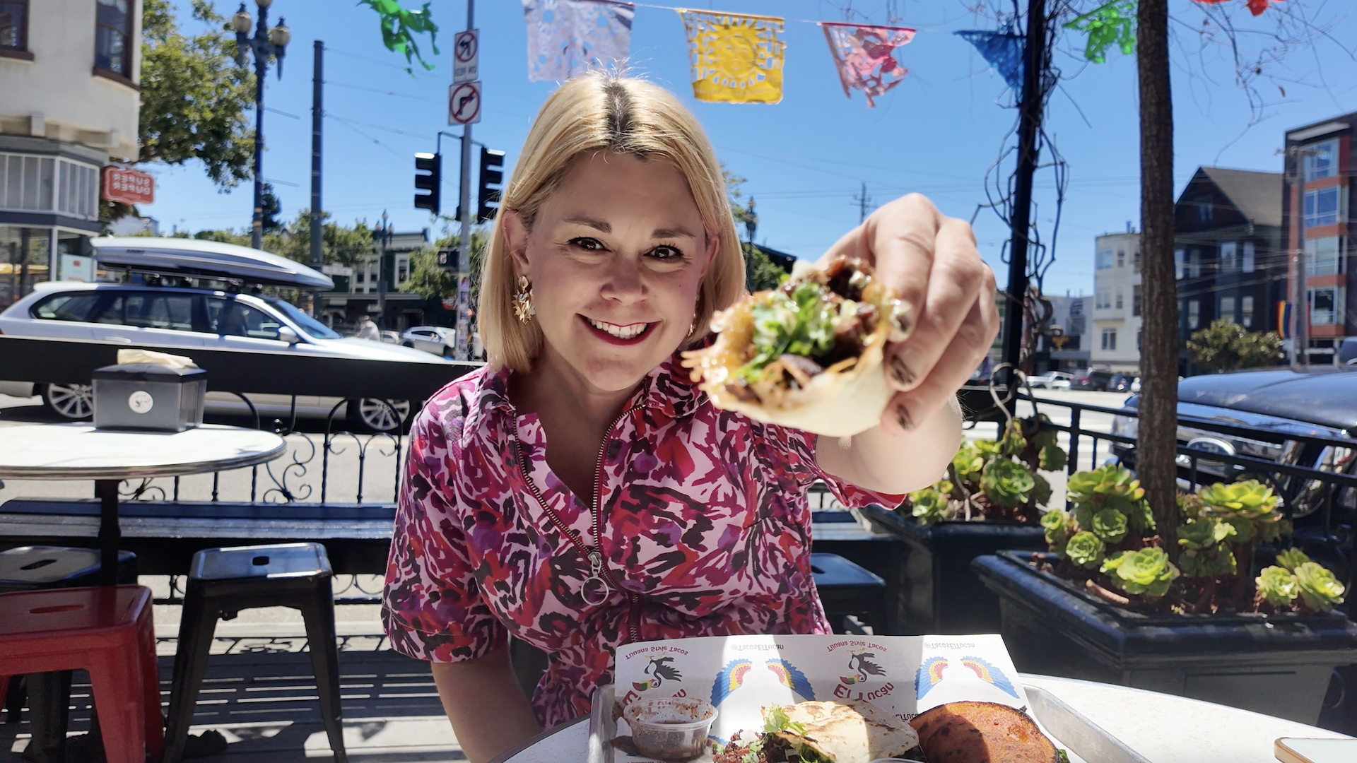 woman holding taco 