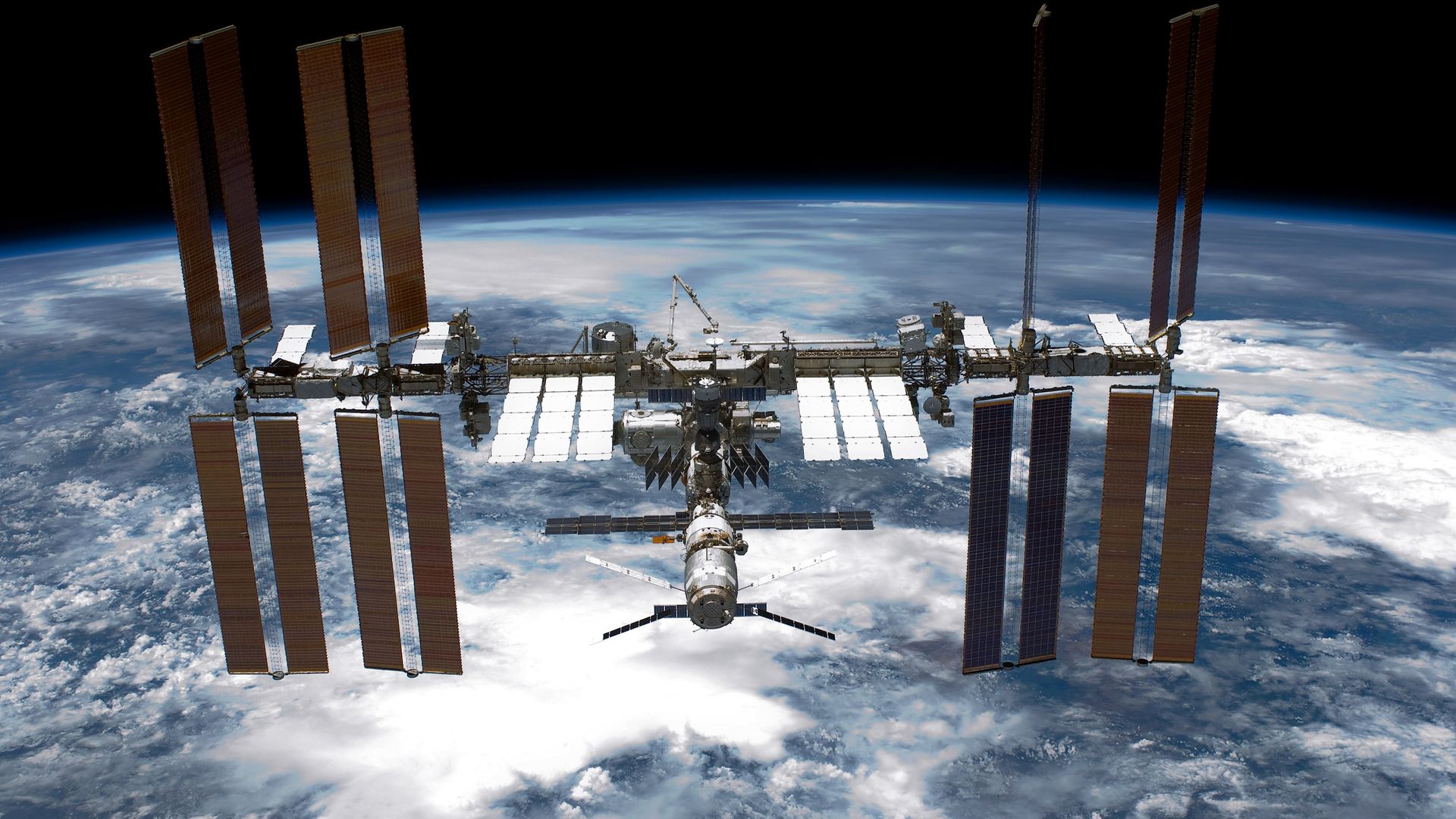 Back dropped by planet Earth the International Space Station (ISS) is seen from NASA space shuttle Endeavour in 2005