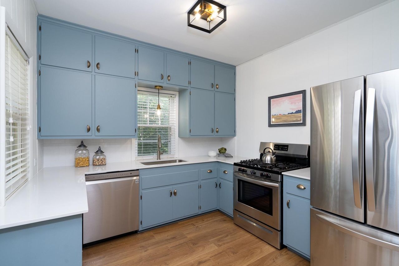 kitchen with modern appliances and grey-blue cabinets