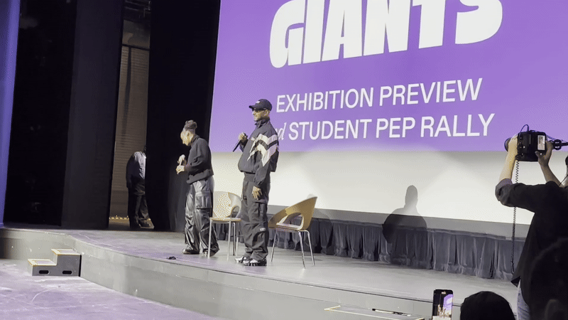 Alicia Keys and Swizz Beatz on a stage in richmond in front of sign that says GIANTS