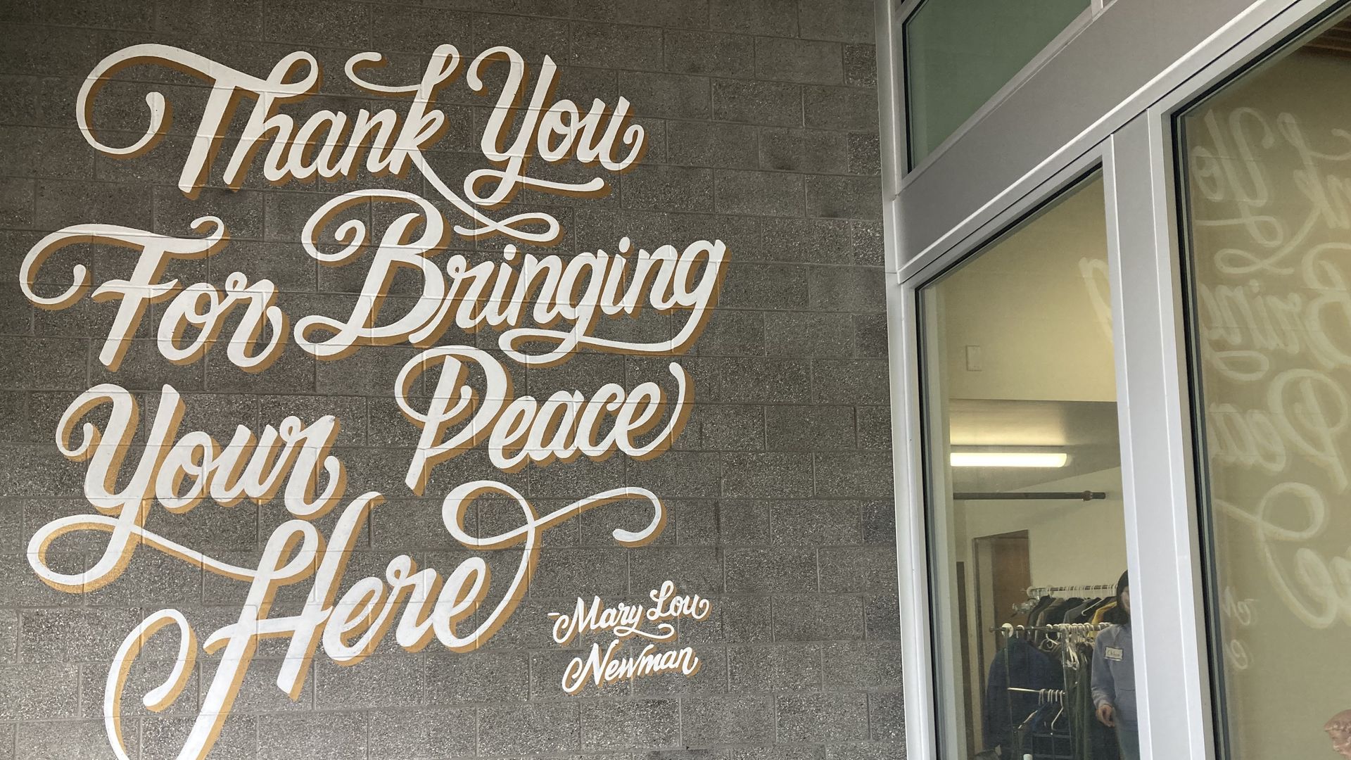 The words "Thank you for bringing your peace here" is painted outside a 57-year-old nonprofit in Seattle. 
