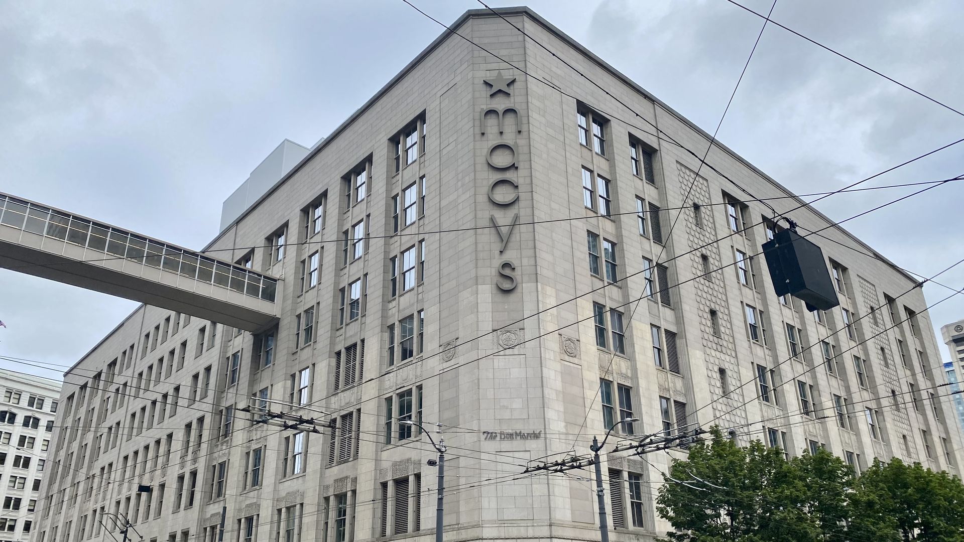 A grey building with letters spelling "Macy's" displayed vertically on the building corner.