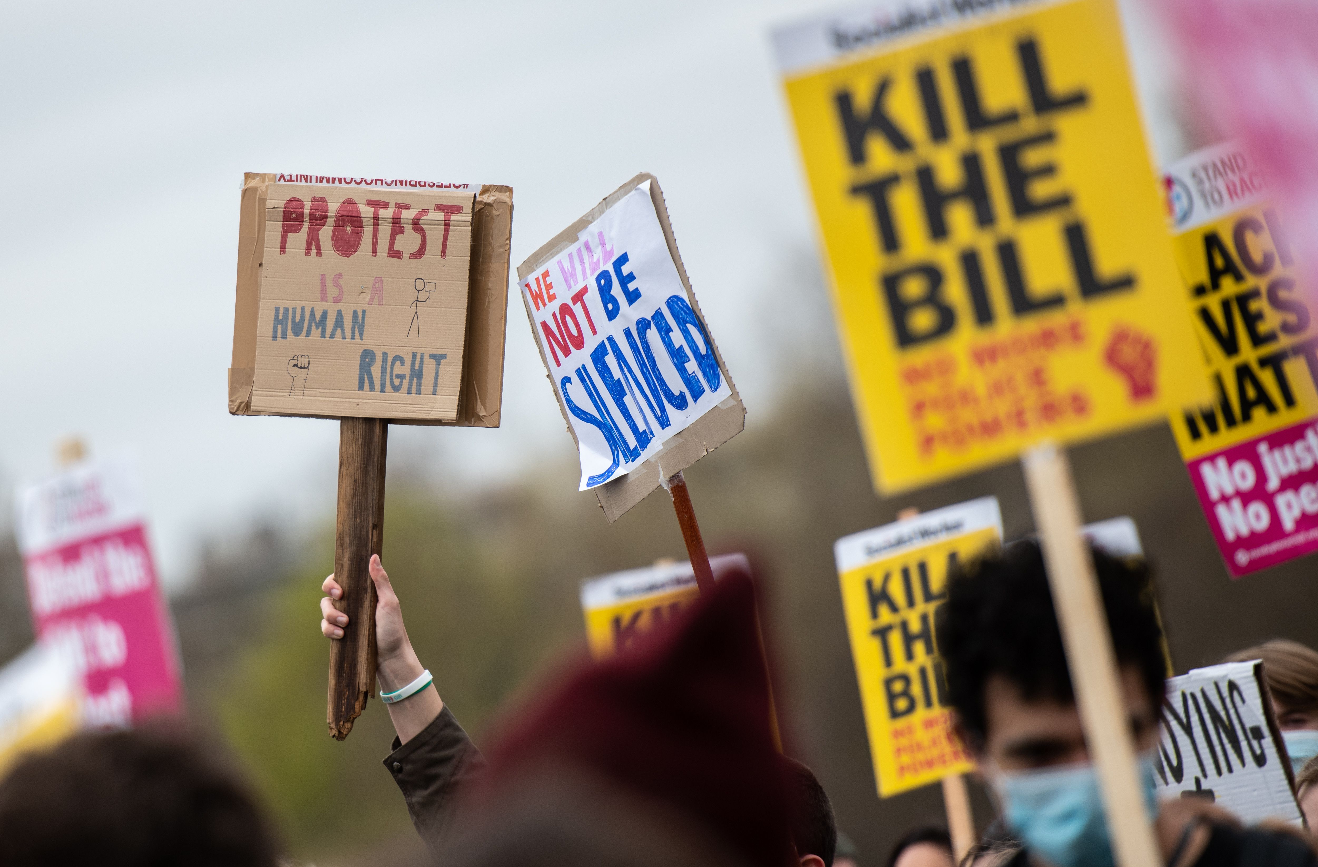 Signs at the protest in London on April 3.
