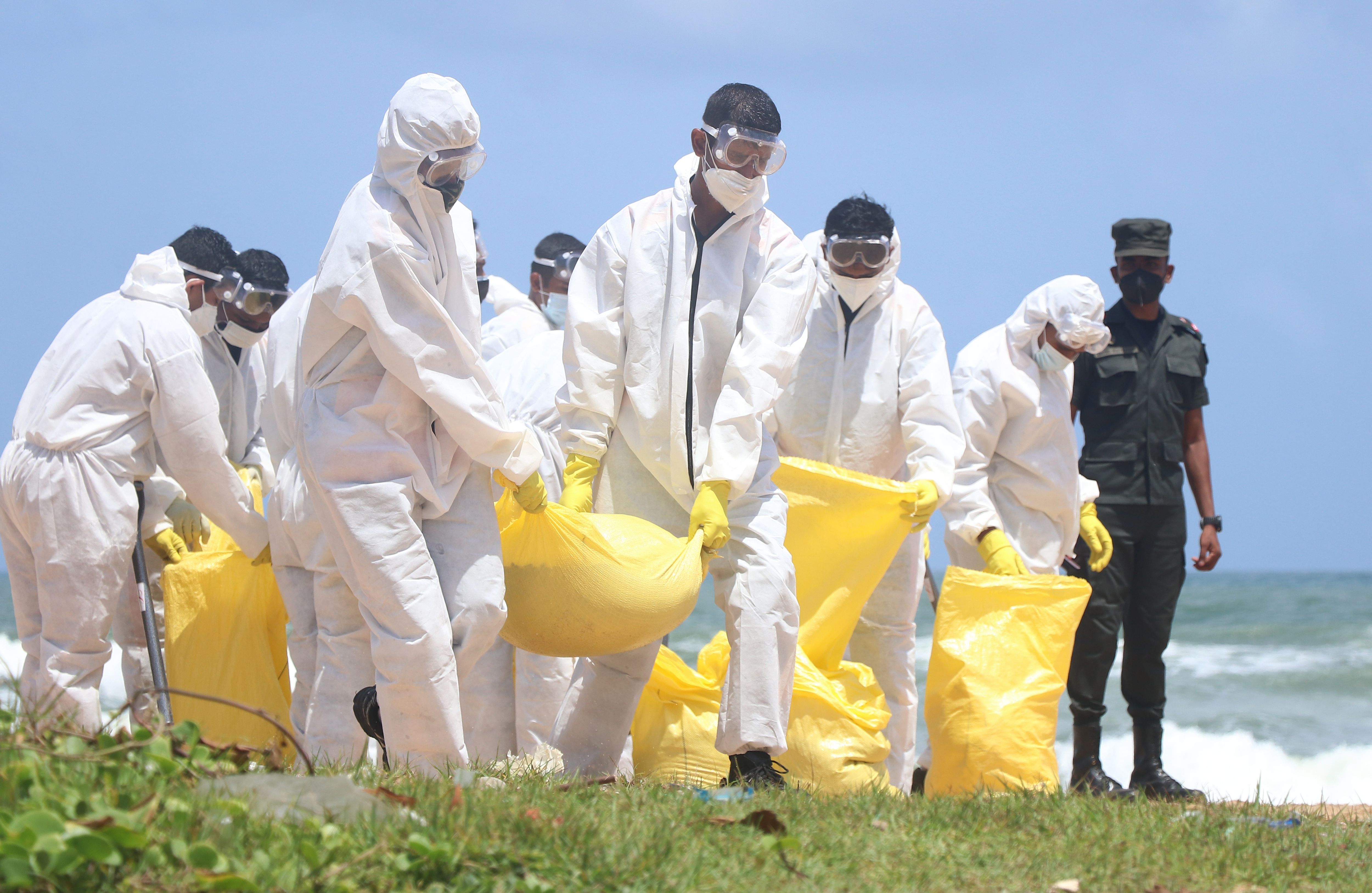 Sri Lanka Army personnel remove debris on the beach at Moratuwa, near Colombo