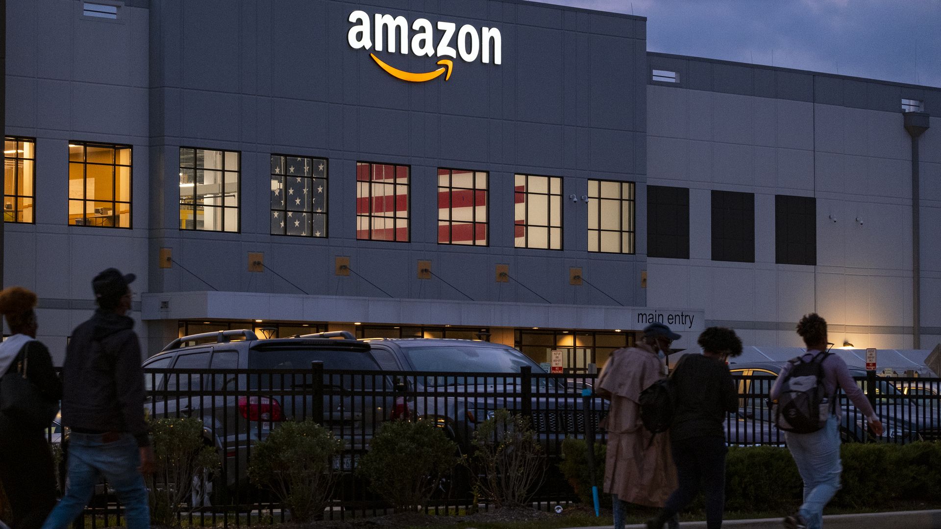 People arrive for work at the Amazon distribution center in the Staten Island borough of New York, Monday, Oct. 25, 2021.