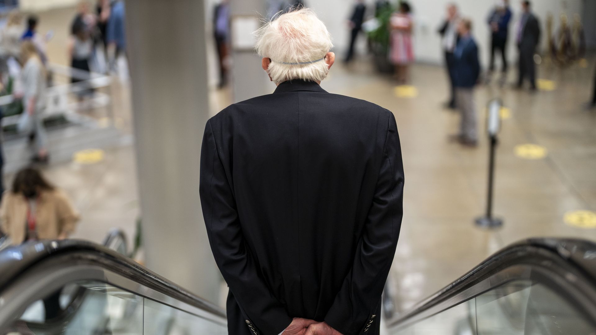Sen. Bernie Sanders is seen descending on a Senate escalator.