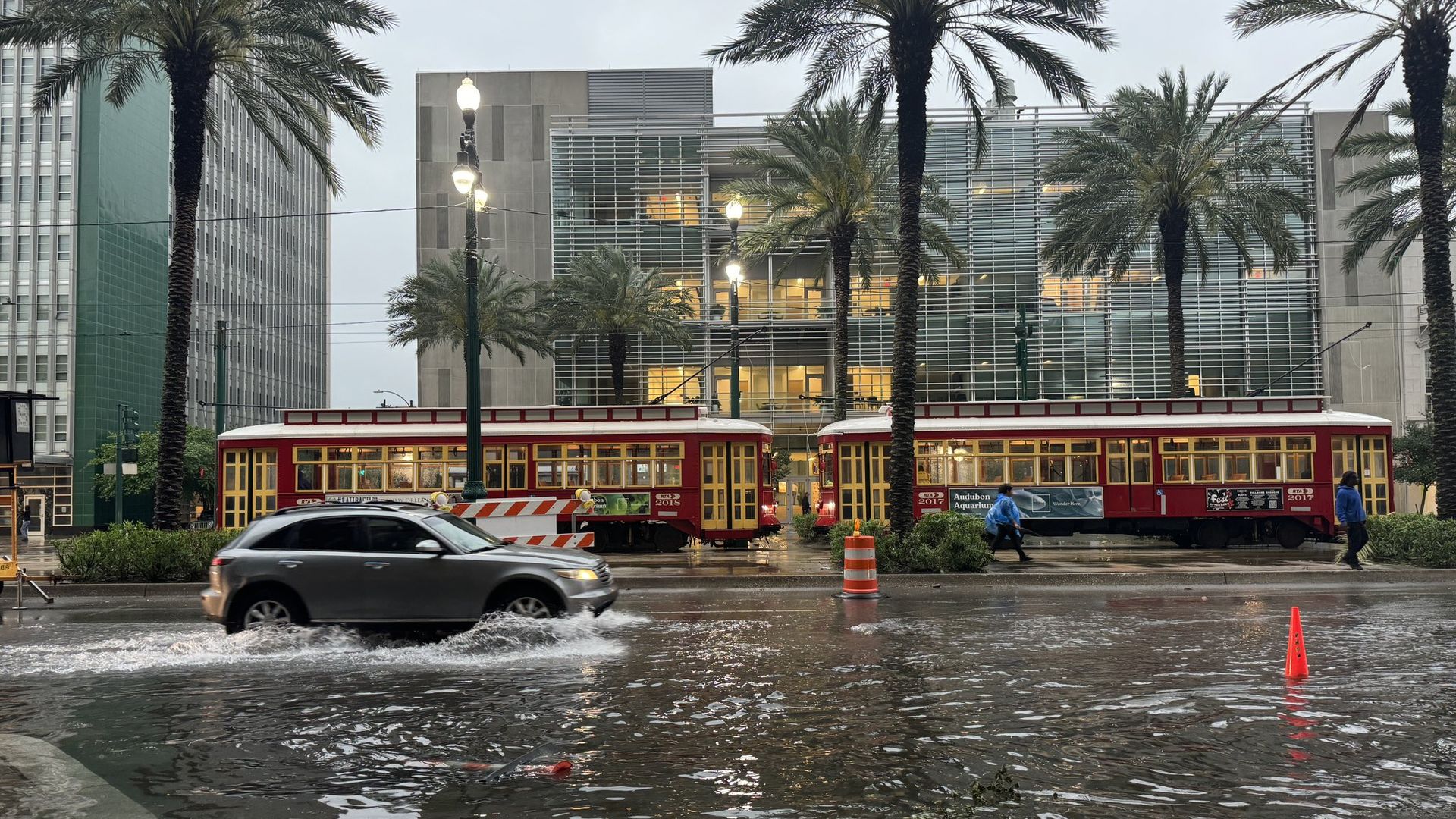 Photo shows an SUV driving through a flooded Canal Street.