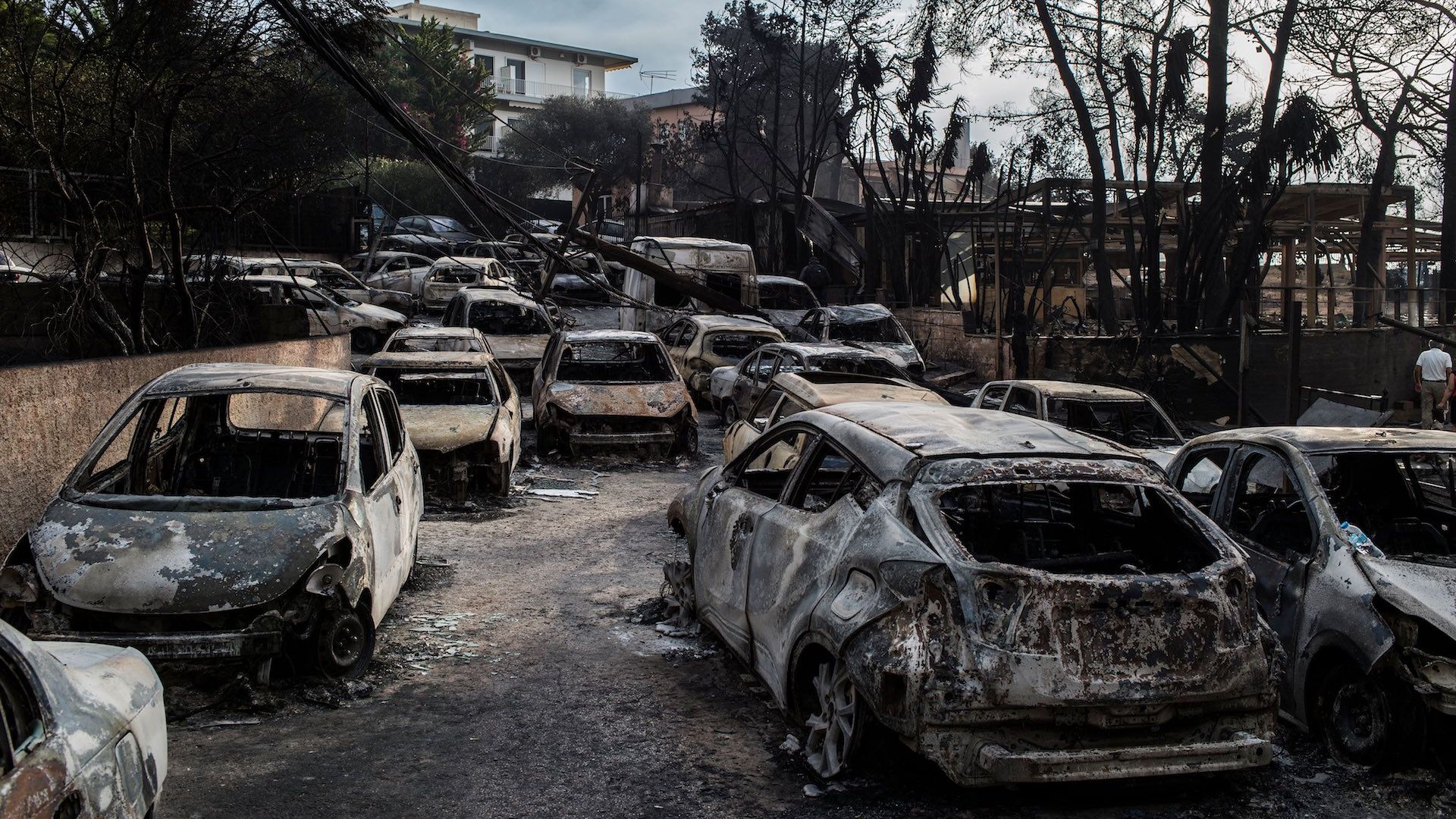 This photo taken on July 24, 2018 show cars burnt following a wildfire at the village of Mati, near Athens.