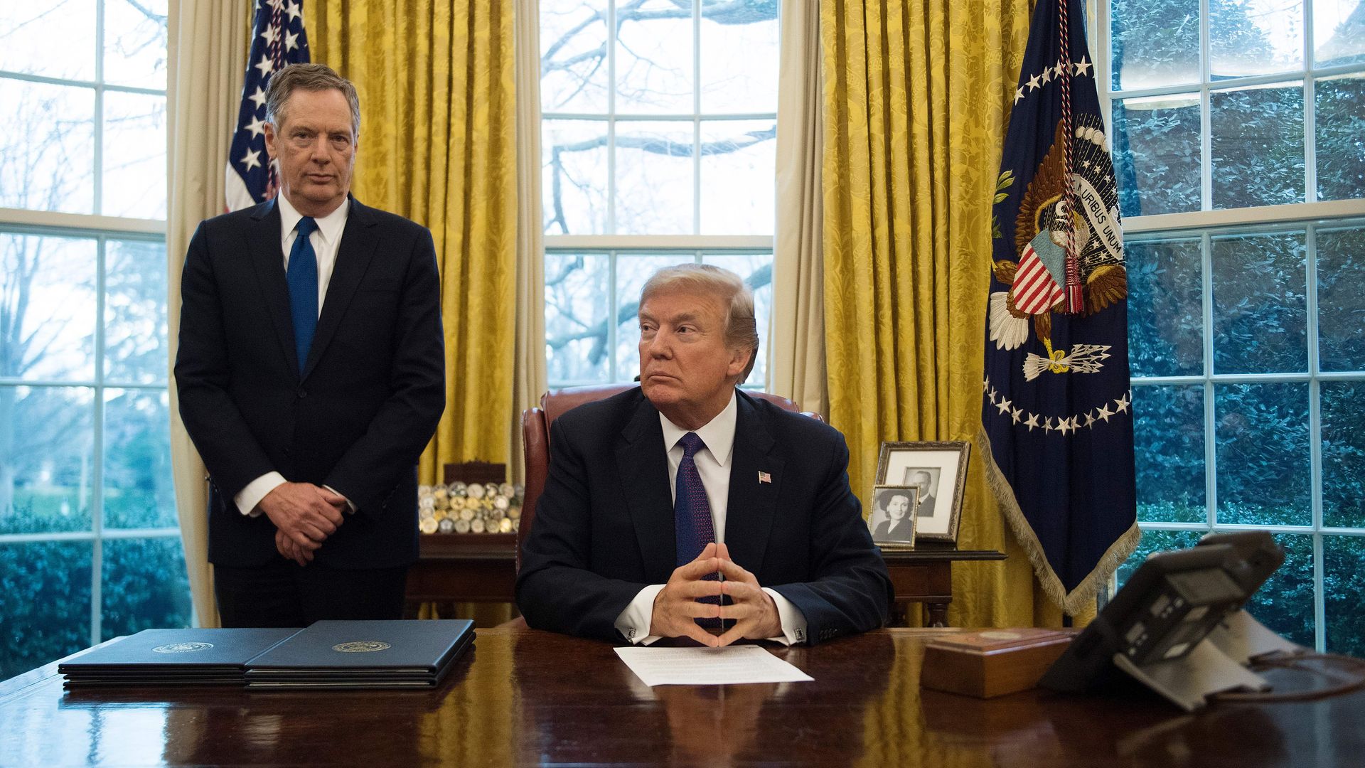 President Donald Trump sits with United States Trade Representative Robert Lighthizer in the Oval Office of the White House in Washington, DC, on January 23, 2018.