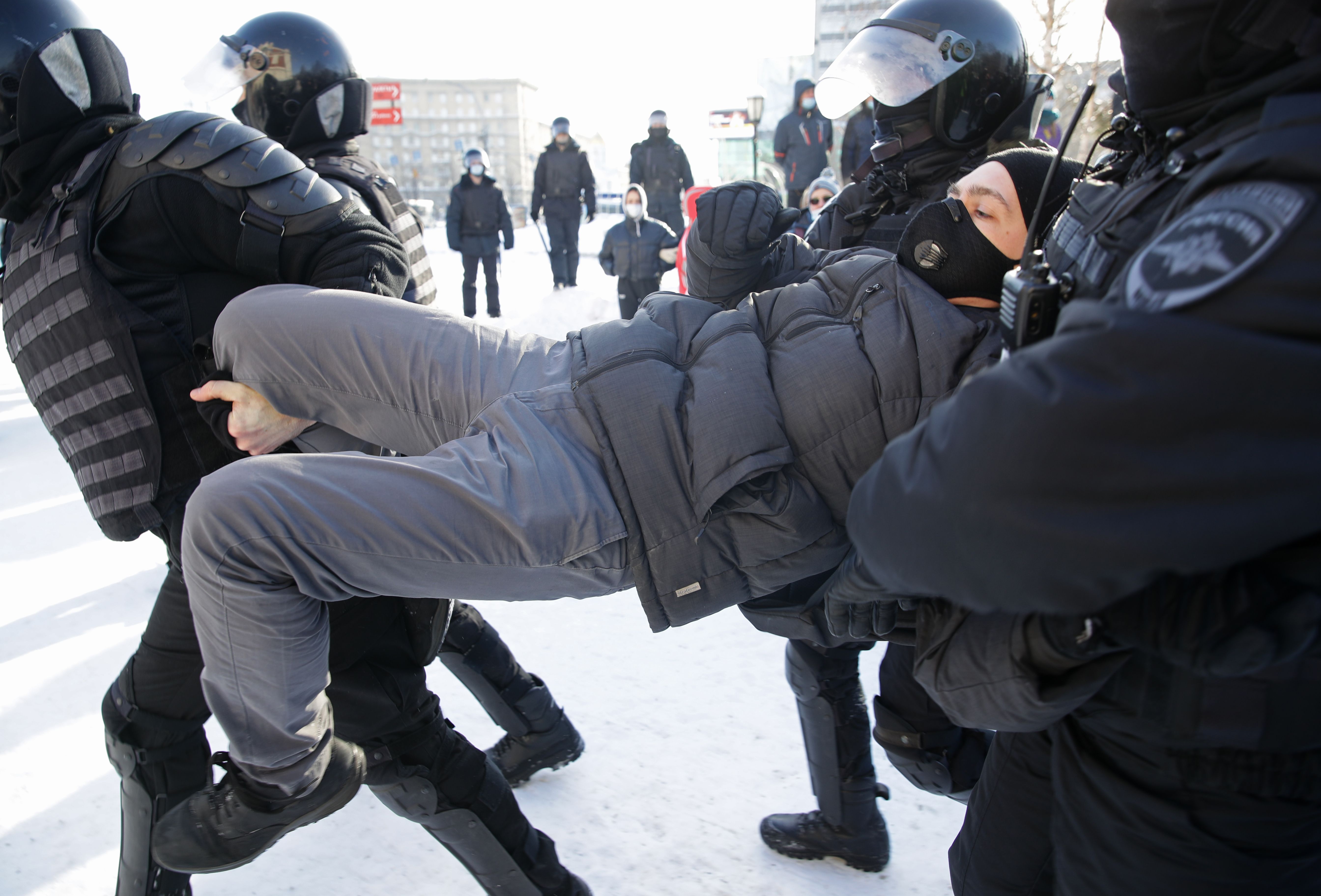 Riot police officers detain a demonstrator during an unauthorised protest in support of the detained opposition activist Alexei Navalny in central Novosibirsk. 