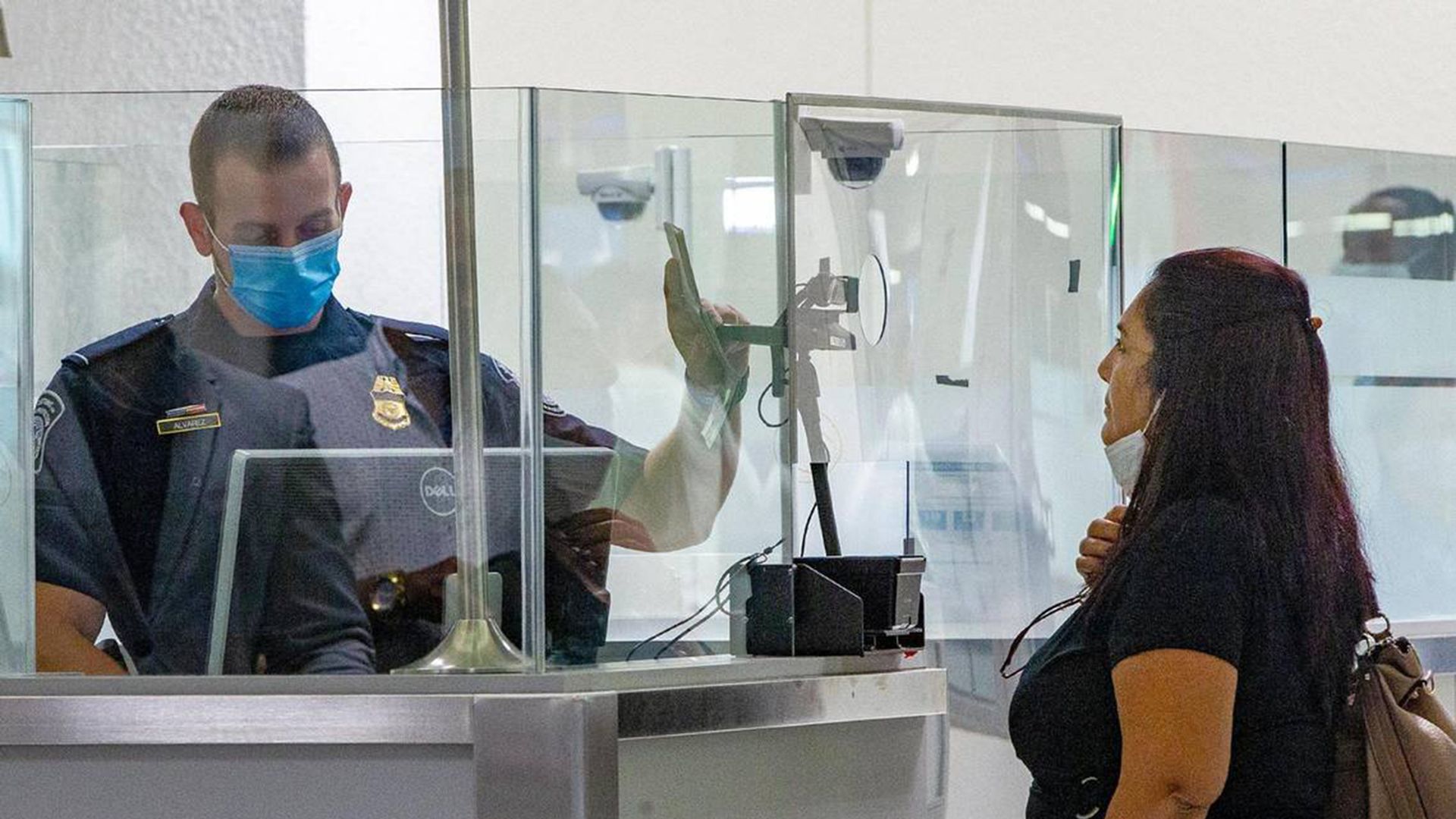 A U.S. Customs and Border Protection officer on Nov. 20, 2020, checks a passenger arriving on an international flight using facial-recognition technology to automate the manual document checks required for admission into the United States. 