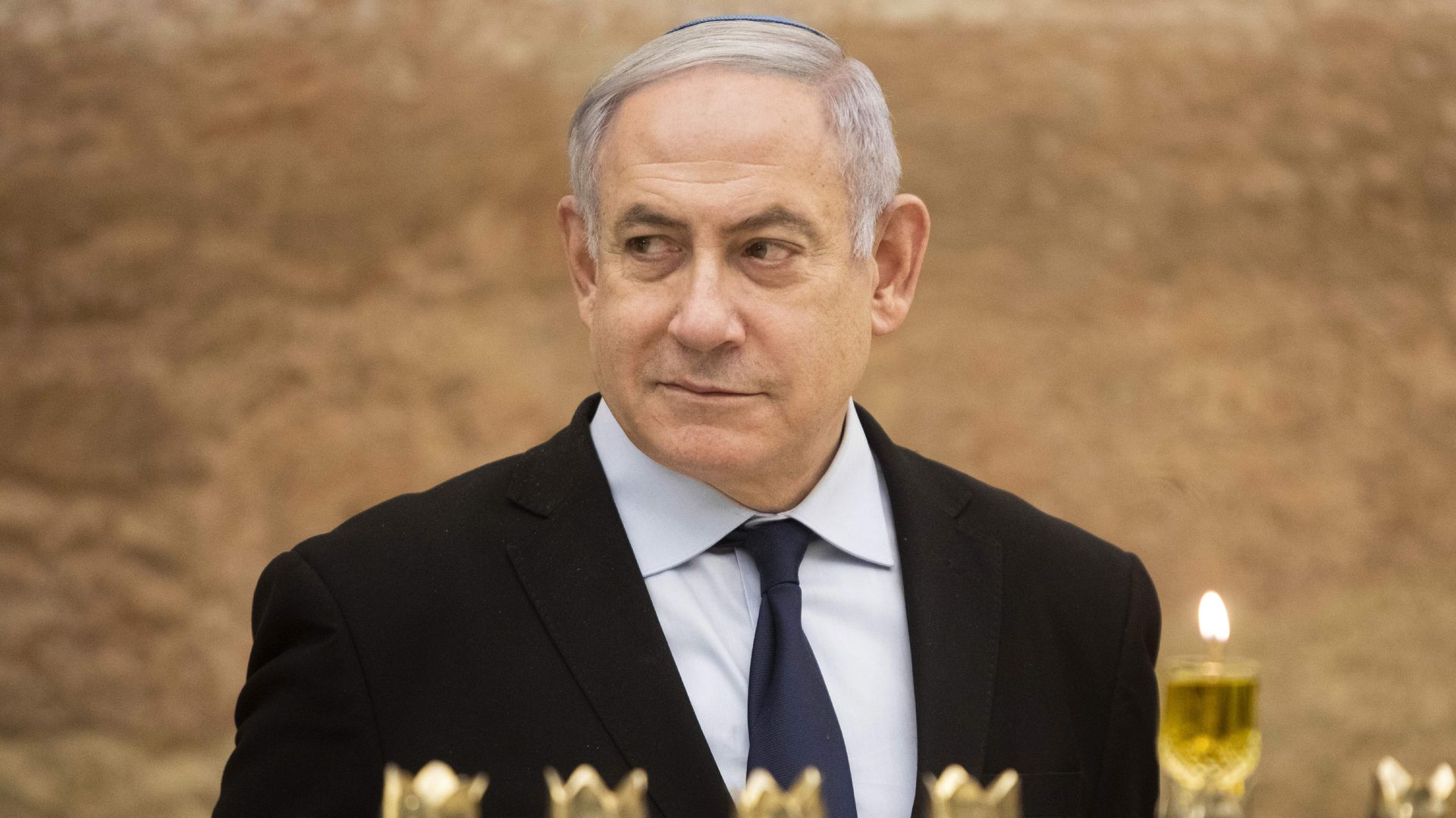 Israeli Prime Minister Benjamin Netanyahu looks on after lighting a Hanukkah candle at the Western Wall, Judaism's holiest prayer site, in the Old City of Jerusalem on December 22