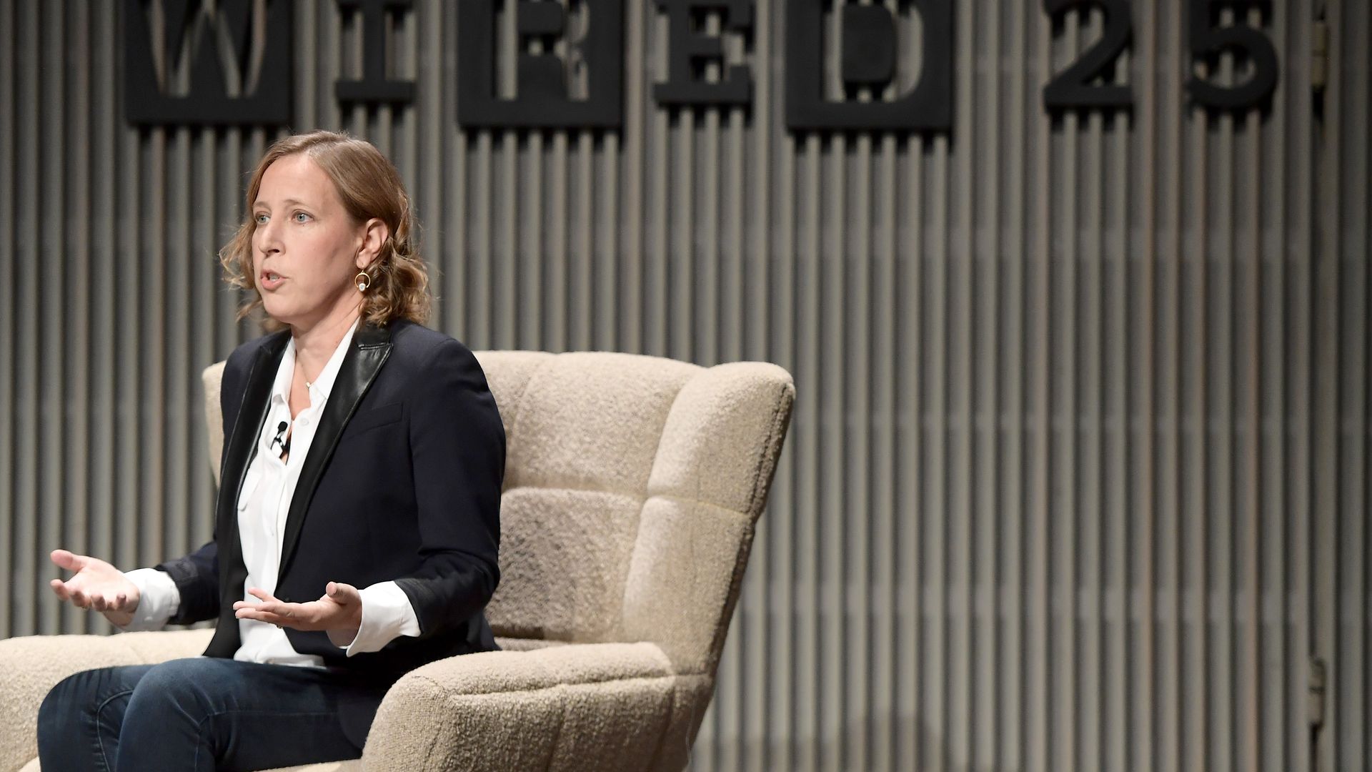 Susan Wojcicki sits onstage behind a sigh that says WIRED25