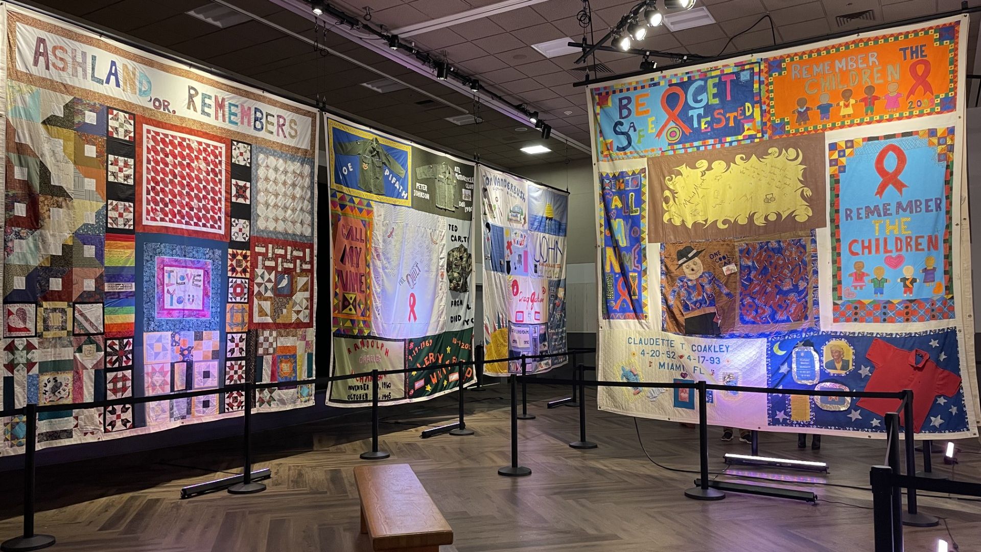 A photo of quilts displayed in a museum.