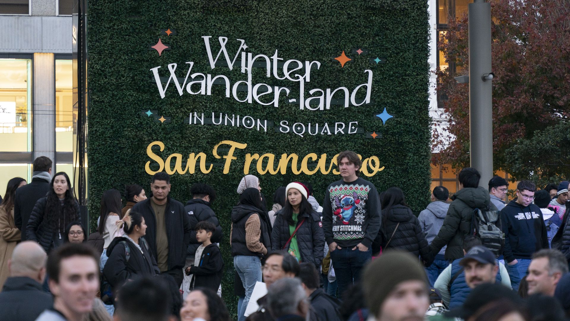 Photo of people crowded around a sign that says "Winter Wonder-land in Union Square San Francisco"