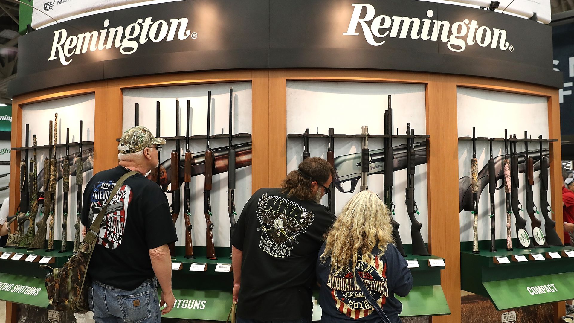 Attendees look at a display of Remington shotguns during the NRA Annual Meeting & Exhibits at the Kay Bailey Hutchison Convention Center on May 5, 2018 in Dallas, Texas.