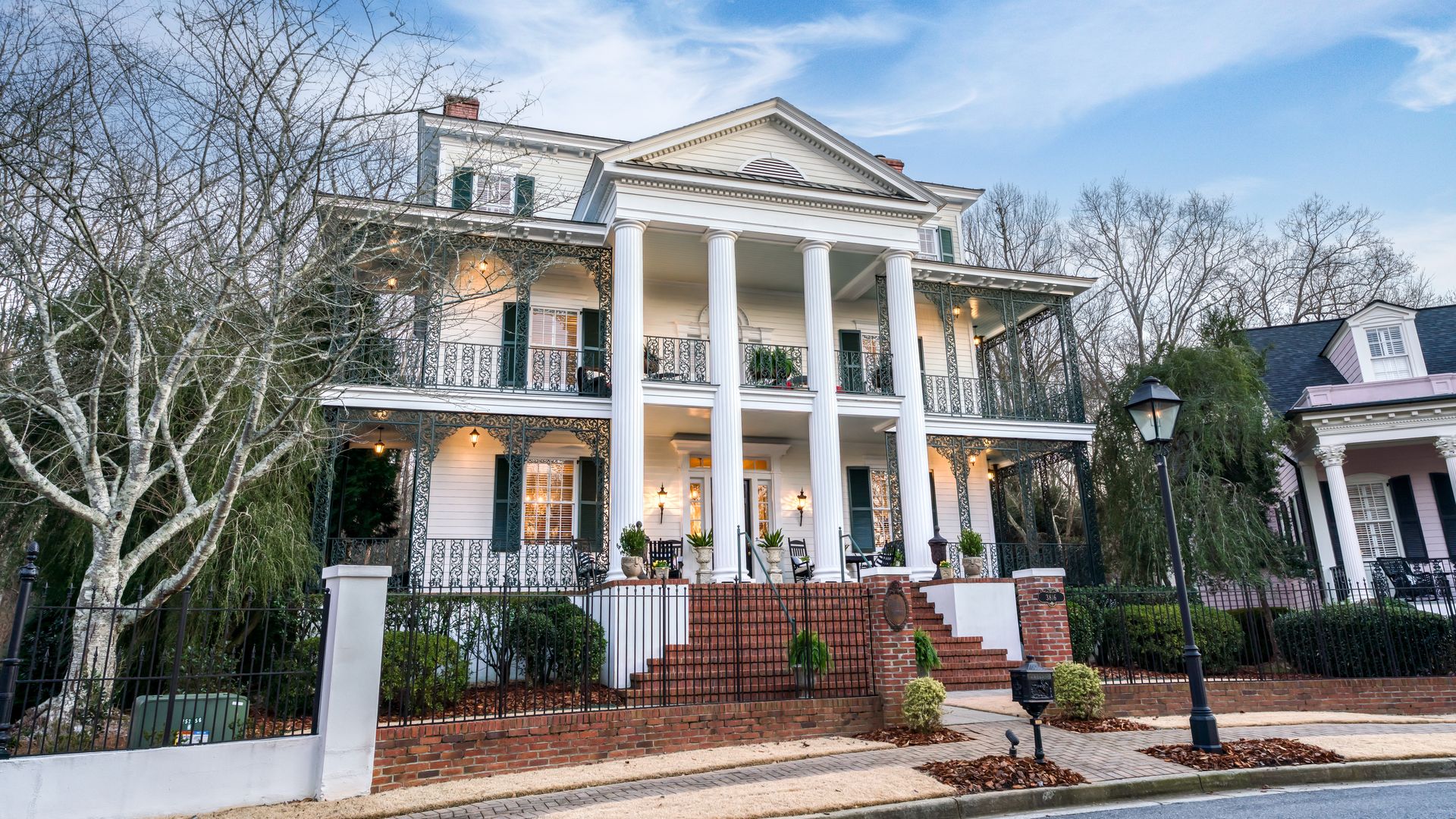 A New Orleans-style antebellum house in a subdivision cul-de-sac