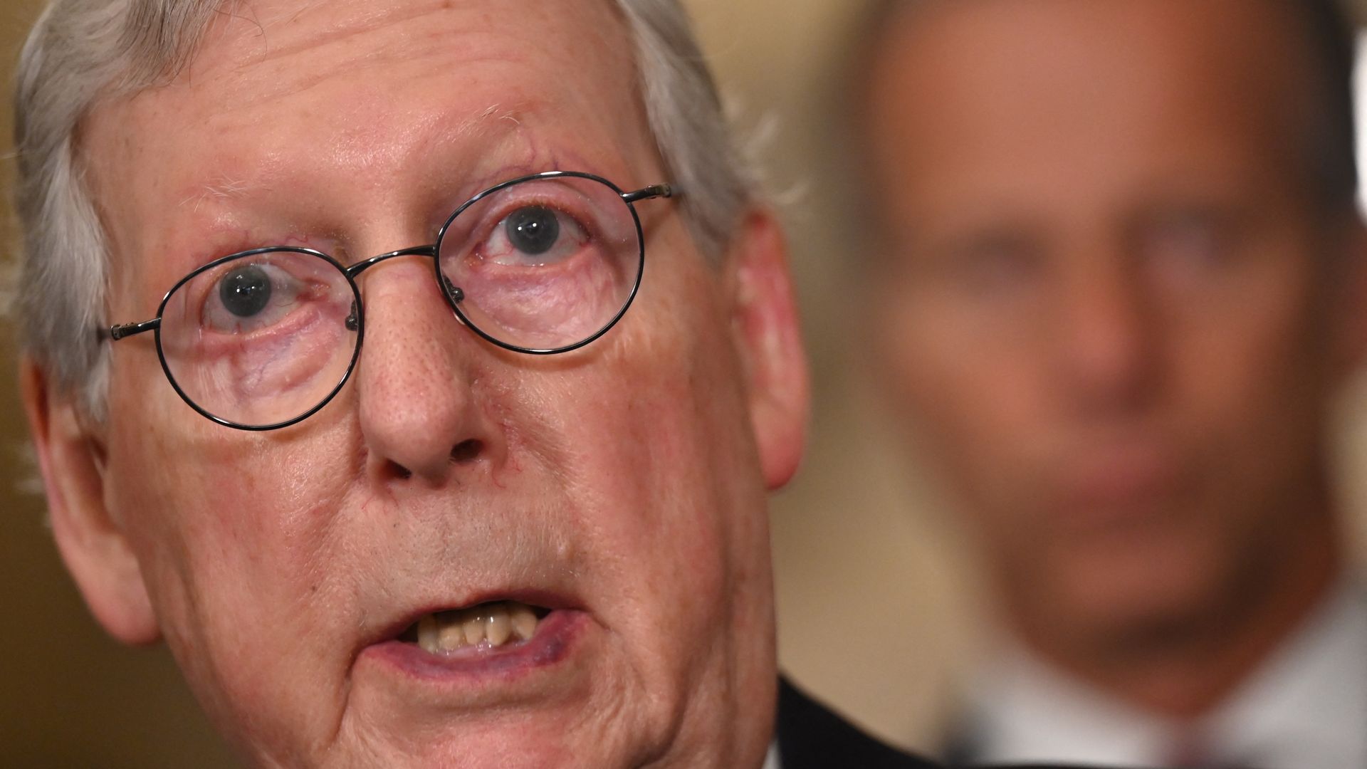 Senate Minority Leader Mitch McConnell is seen addressing reporters.