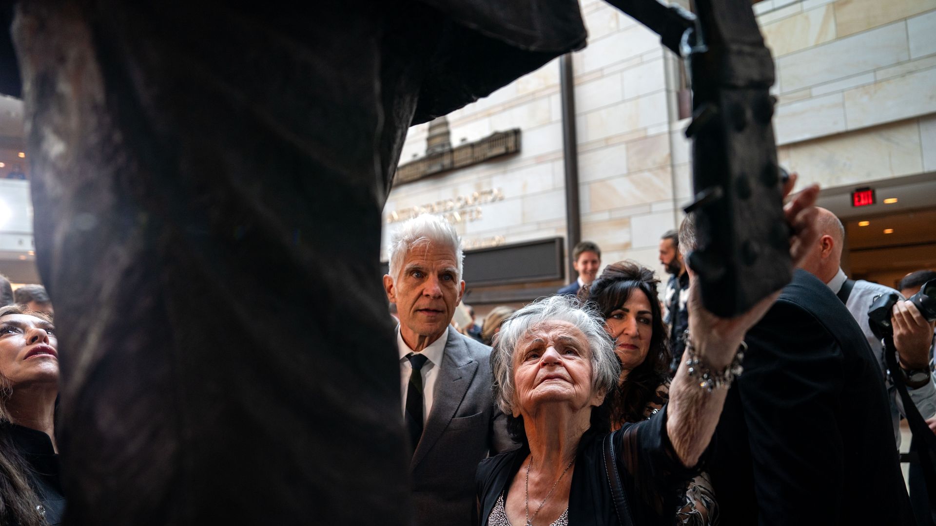 Joanne Cash, sister of American singer-songwriter Johnny Cash reaches out to touch the statue of her late brother after it was unveiled in Emancipation Hall at the U.S. Capitol on September 24, 2024 in Washington, DC. 