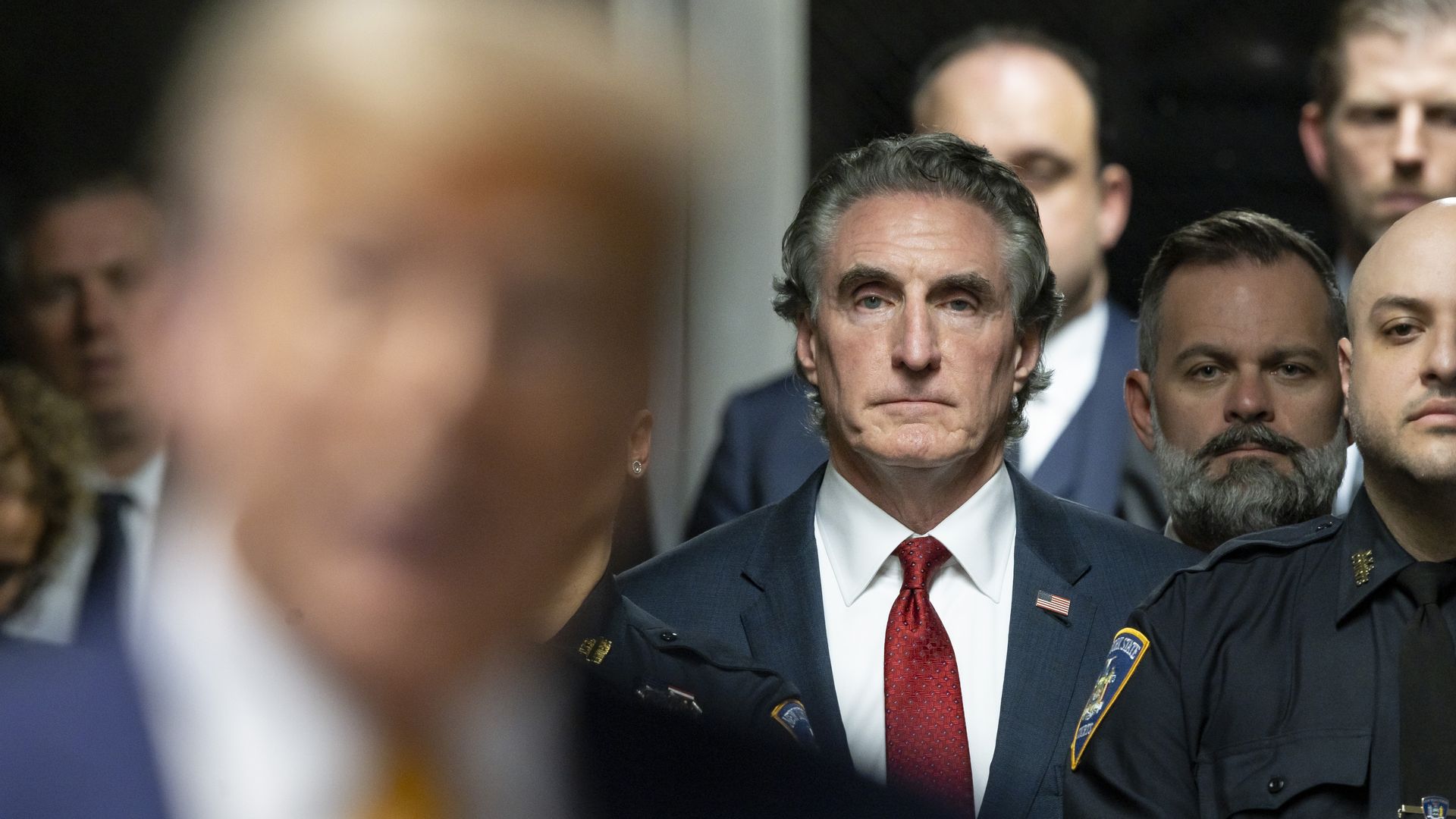 Governor Doug Burgum (C) of North Dakota listens as former U.S. President Donald Trump (L) speaks to reporters at the end of the day's proceedings in his criminal trial for allegedly covering up hush money payments at Manhattan Criminal Court on May 14, 2024 in New York City. Former U.S. President D