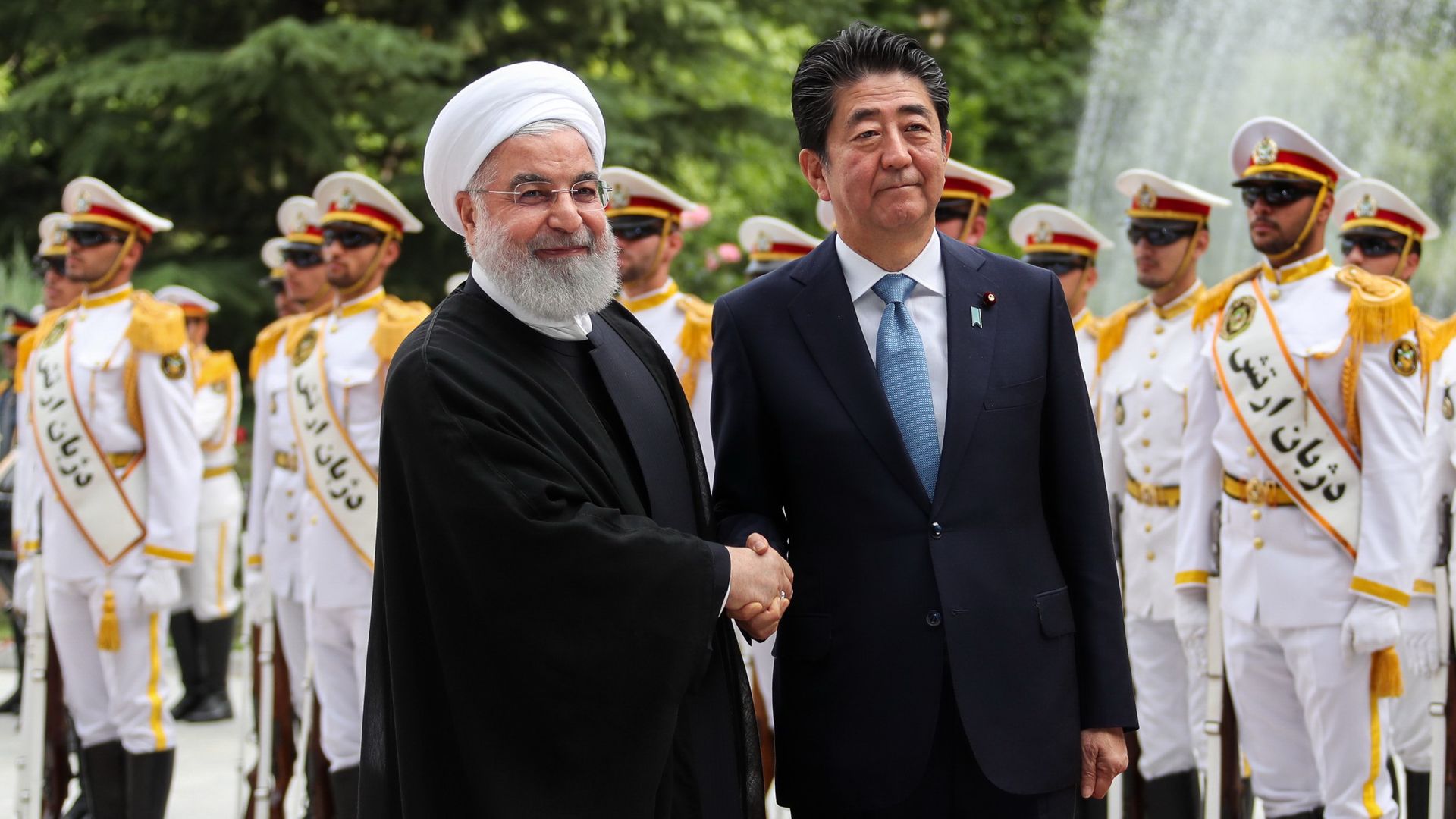 Shinzo Abe and Hassan Rouhani shaking hands