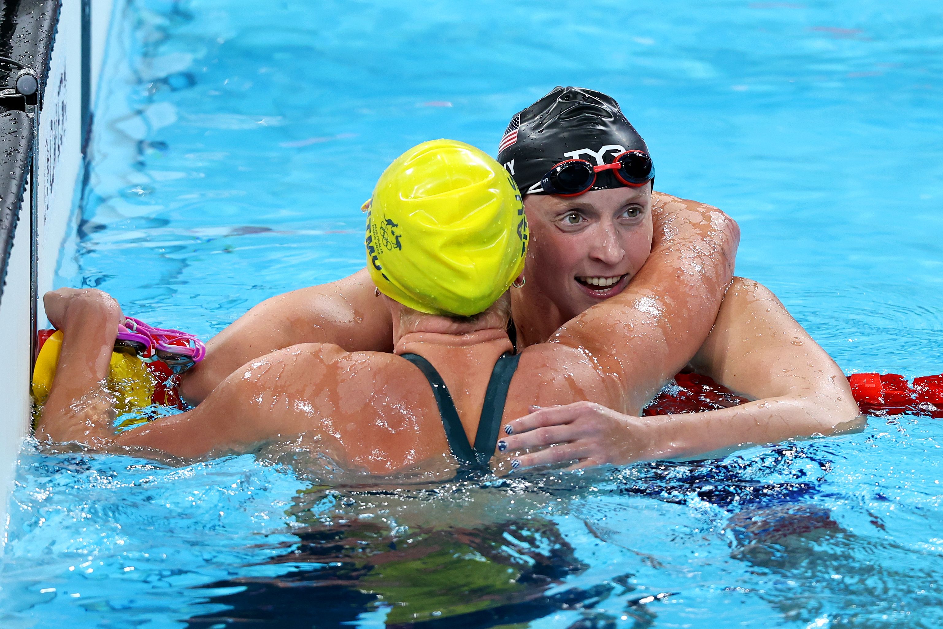 Katie Ledecky of Team United States and Ariarne Titmus of Team Australia celebrate after winning bronze and gold in the Women's 400m Freestyle Final on day one of the Olympic Games Paris 2024 at Paris La Defense Arena on July 27, 2024 in Nanterre, France. 