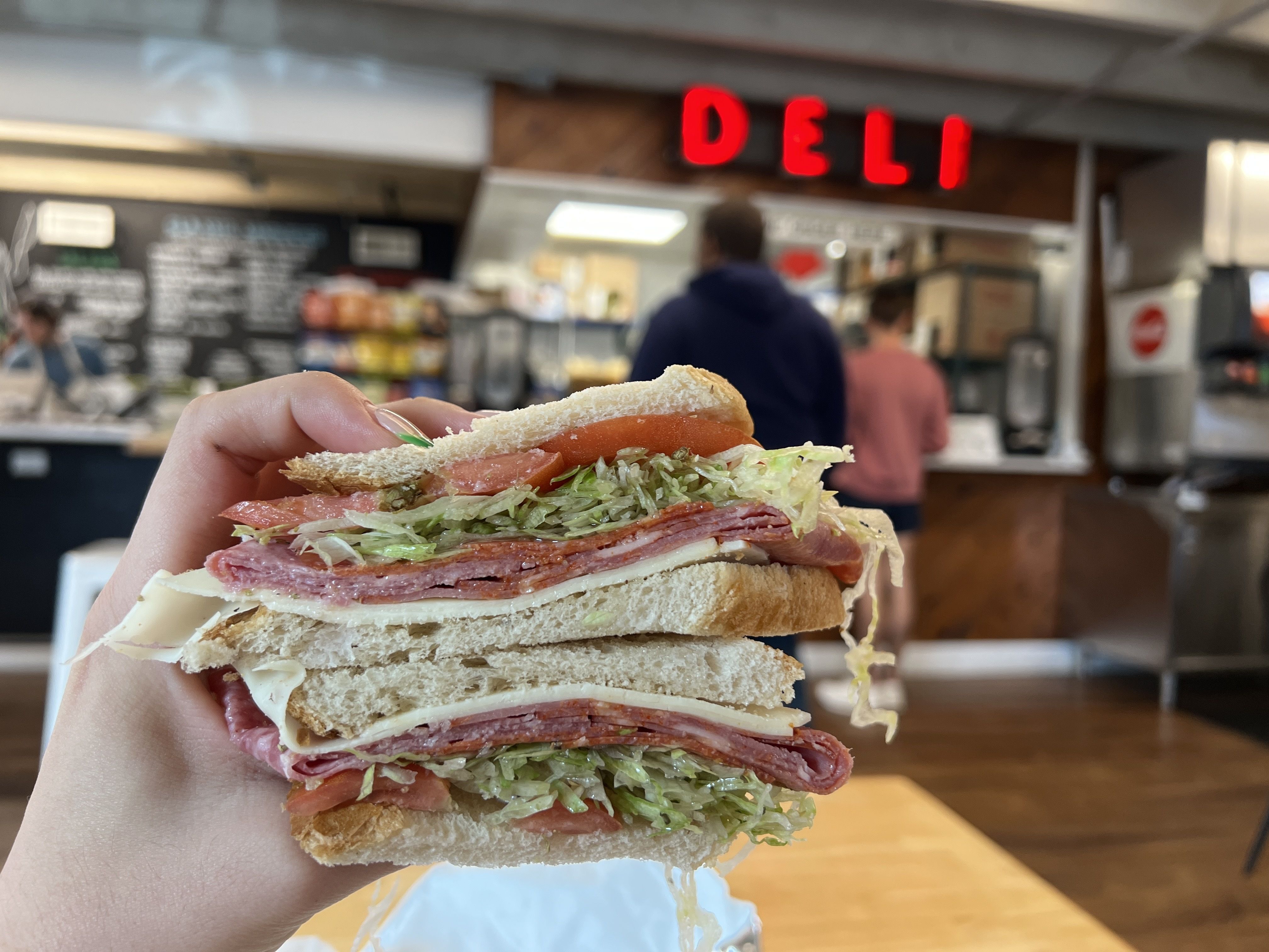 hand holding sandwich