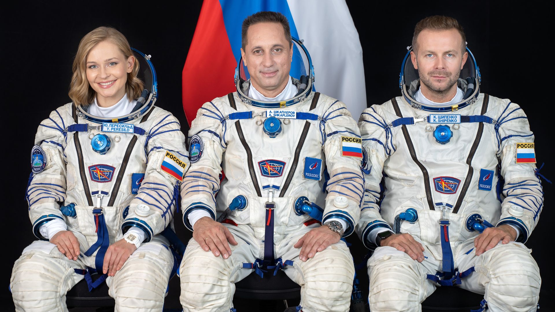 Picture of actor Yulia Peresild, cosmonaut Anton Shkaplerov and director Klim Shipenko wearing astronaut suits