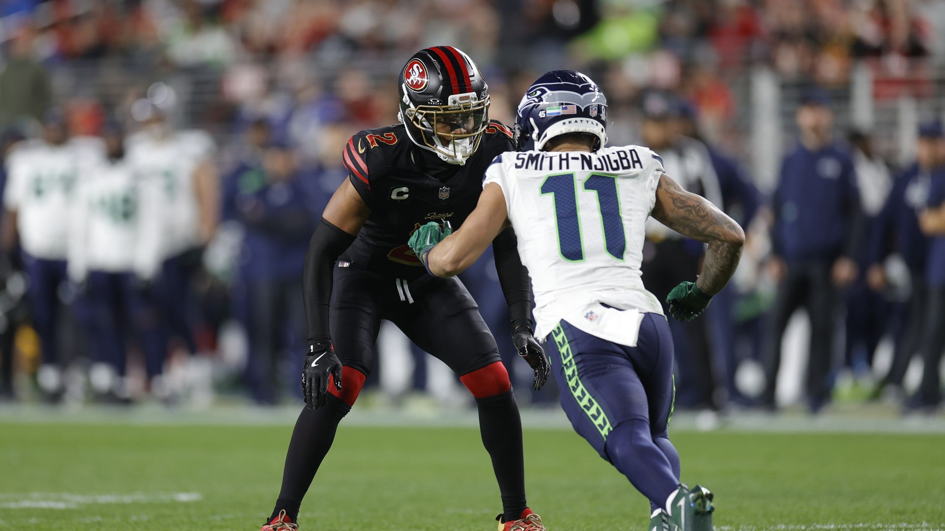 A Seattle Seahawks player faces off against a 49er. 