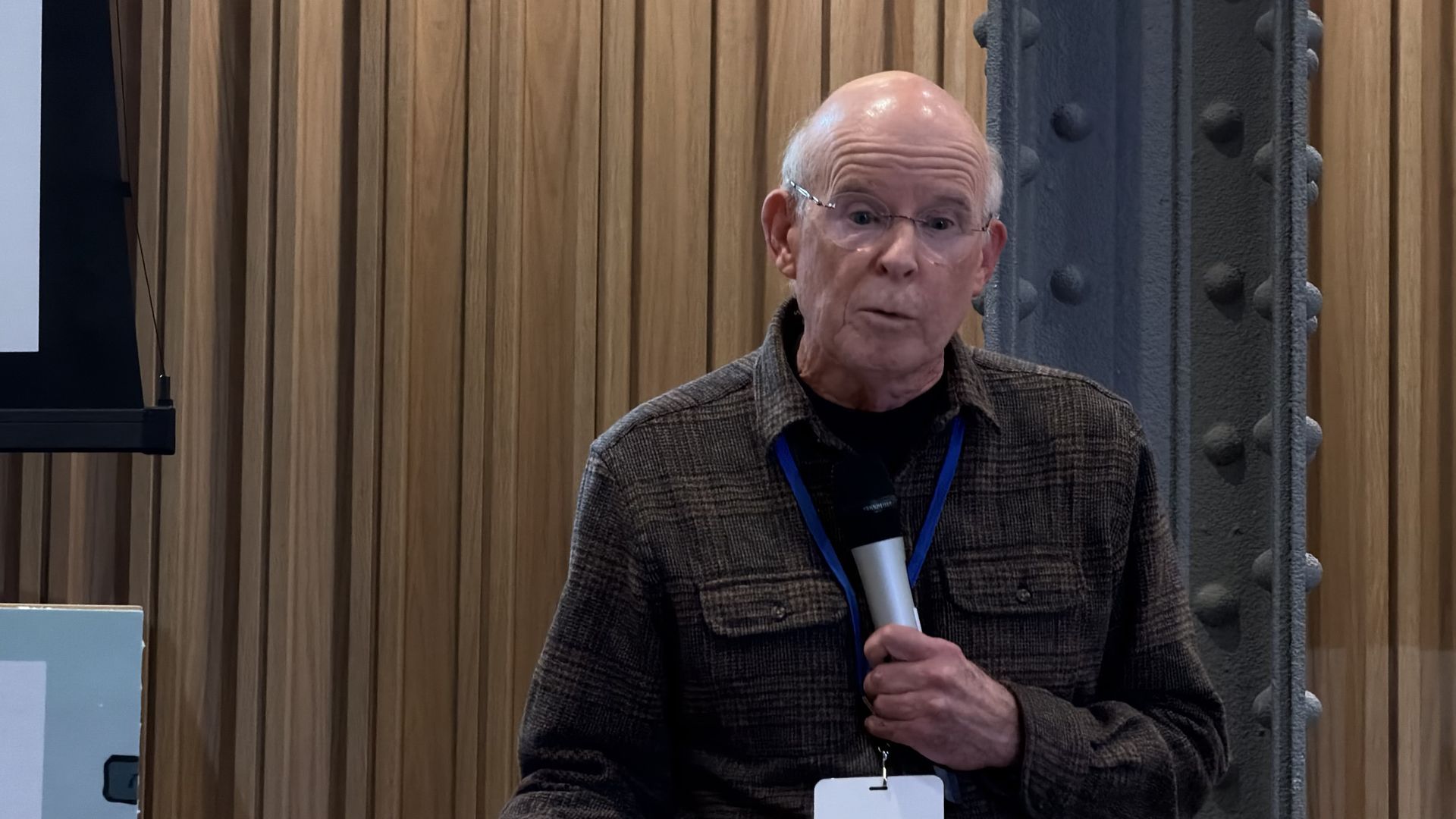 Bobby Corrigan, a renowned rodentologist, addresses a crowd in a downtown City of Boston building during the 2026 National Urban Rat Summit.