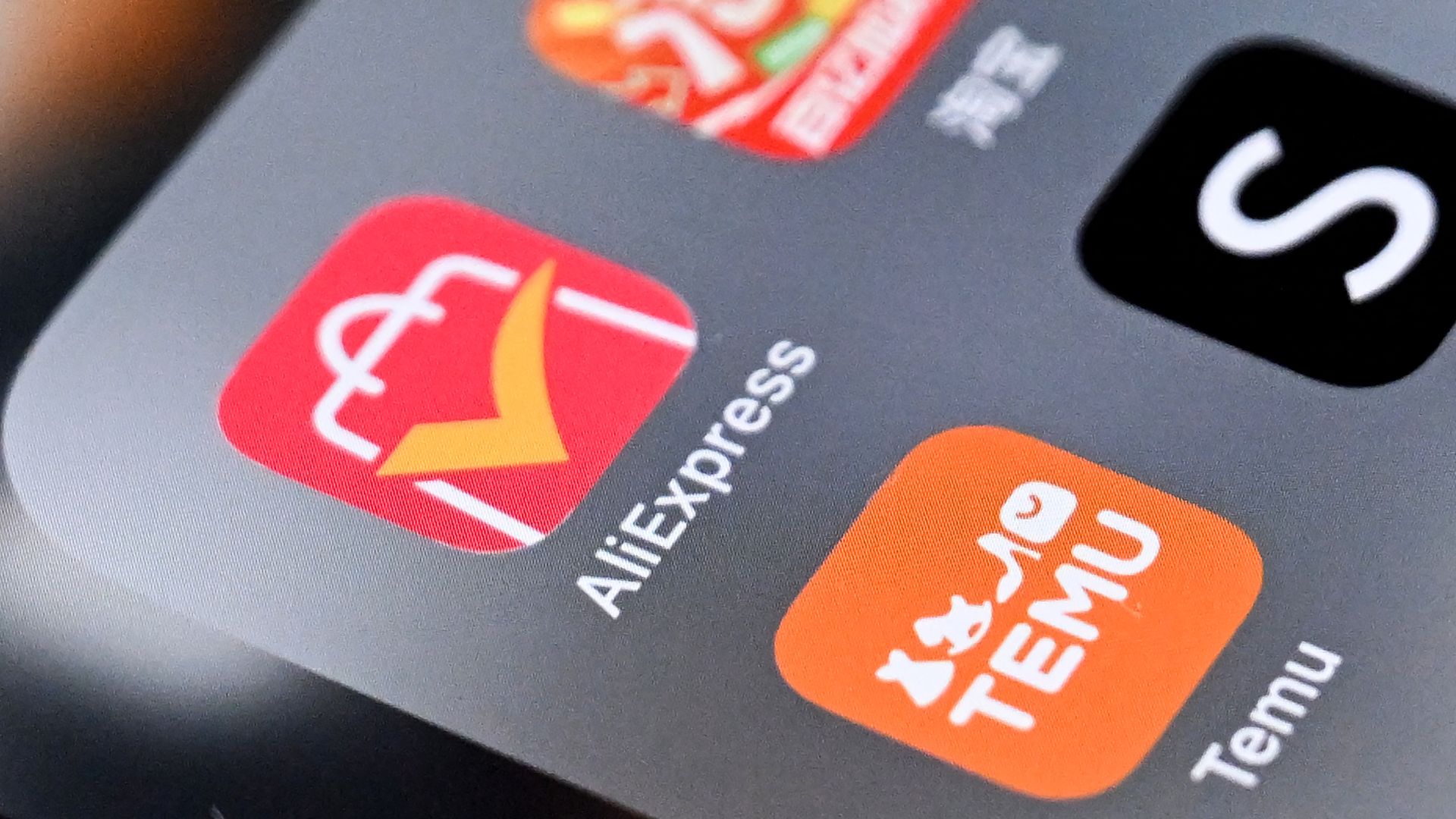 Temu app next to the Shein and AliExpress apps on a smartphone